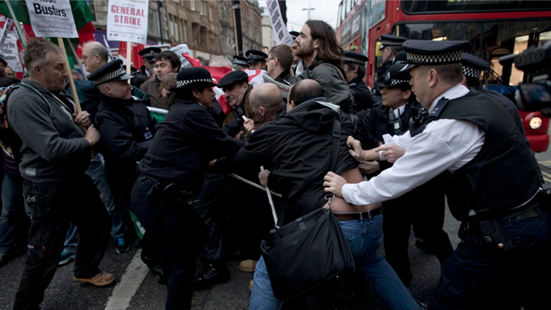 Nov. 14, 2012: Police officers try to push protesters back onto the pavement after they blocked traffic on Oxford Street, London, whilst taking part in a picket and demonstration they said was over dismissals of 28 workers employed by contractors on the Crossrail transport project, for being trade union members.