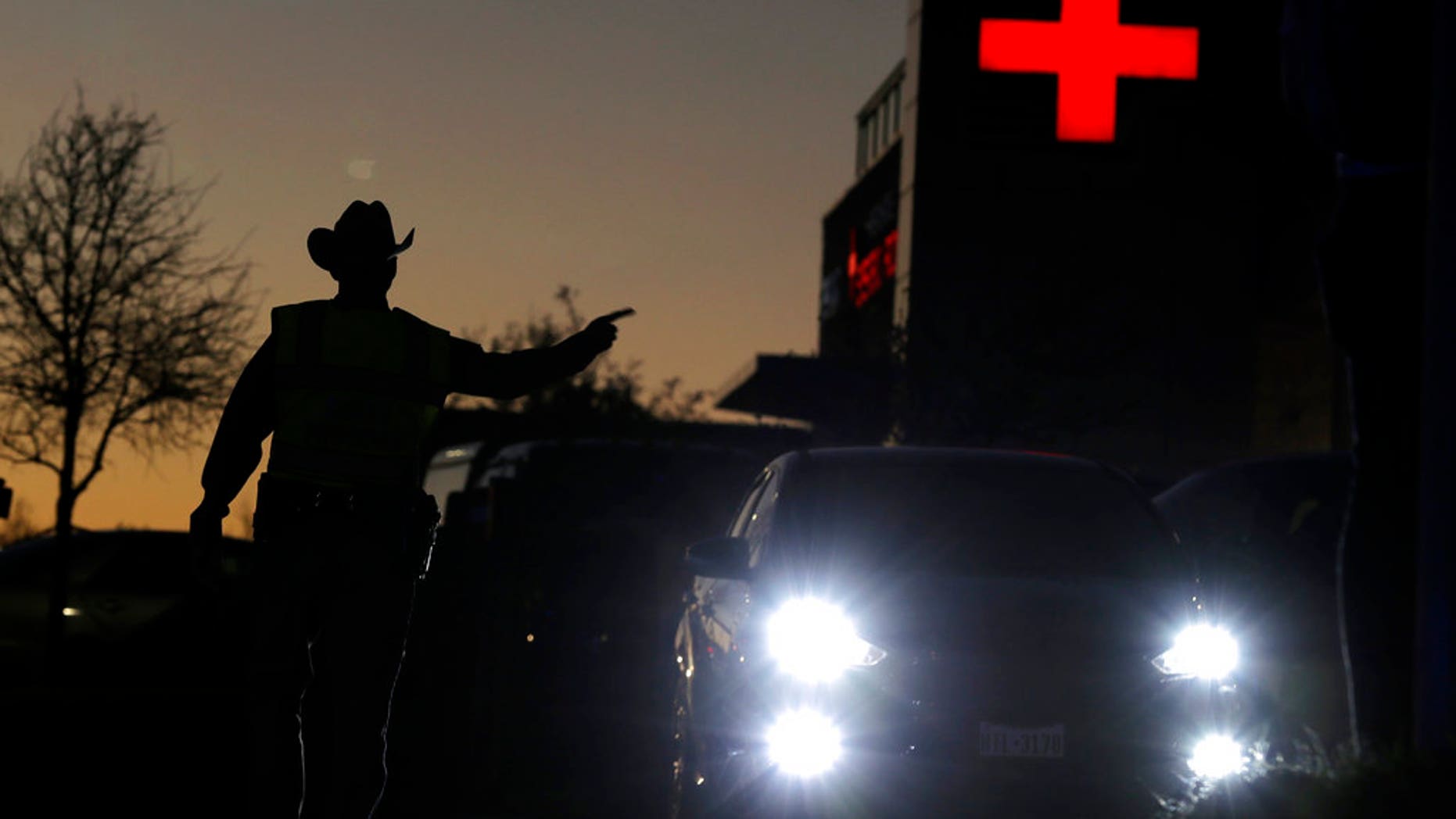 Texas troopers help redirect traffic near the site of another explosion, Tuesday, March 20, 2018, in Austin, Texas. Emergency teams were responding to another reported explosion in Texas' capital, this one at a Goodwill store in the southern part of the city. (Jan Janner/Austin American-Statesman via AP)