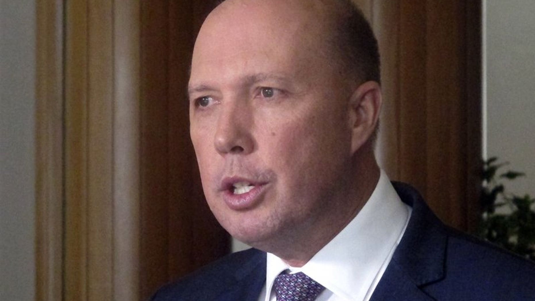 Australia’s Immigration and Border Protection Minister Peter Dutton speaks to reporters at Parliament House in Canberra, Australia (AP)