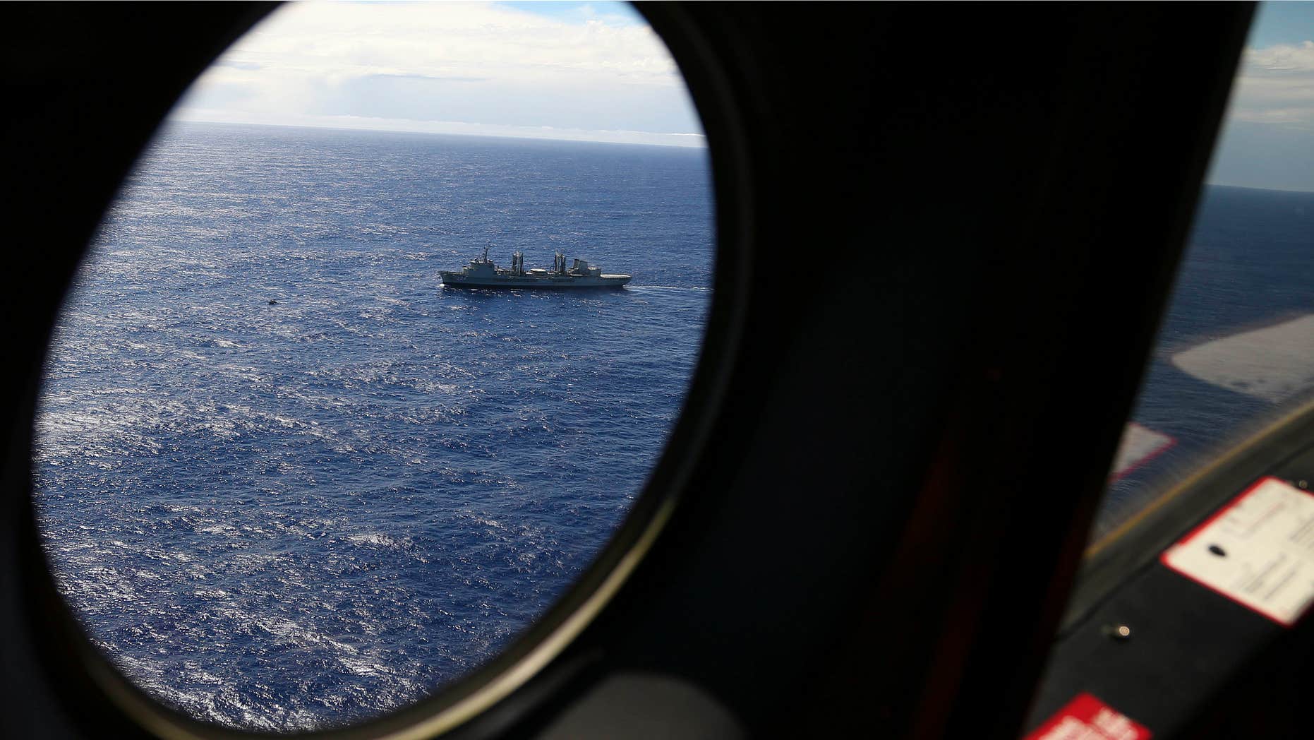March 31, 2014: HMAS Success sails as a Royal New Zealand Air Force P3 Orion flies past while searching for missing Malaysia Airlines Flight 370 in the southern Indian Ocean.