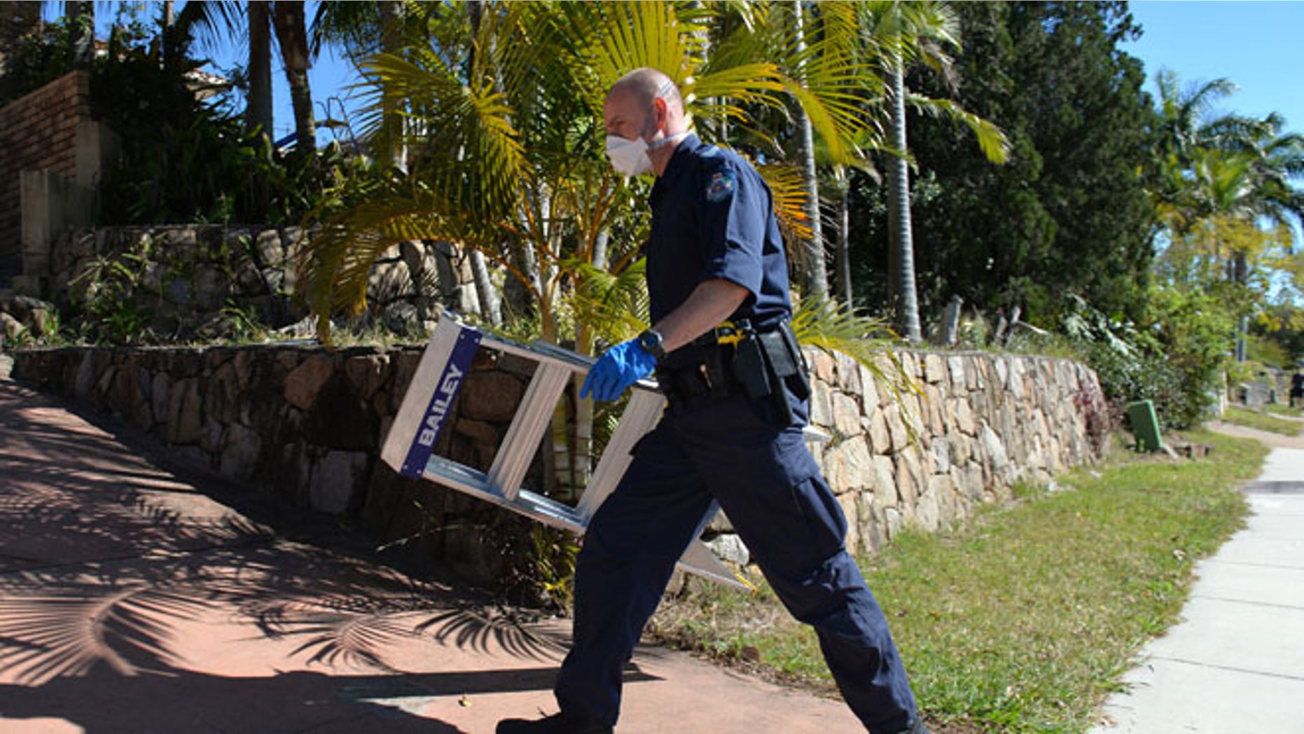 Sept. 18, 2014: A police officer searches a house in Mount Gravatt, Brisbane, Australia