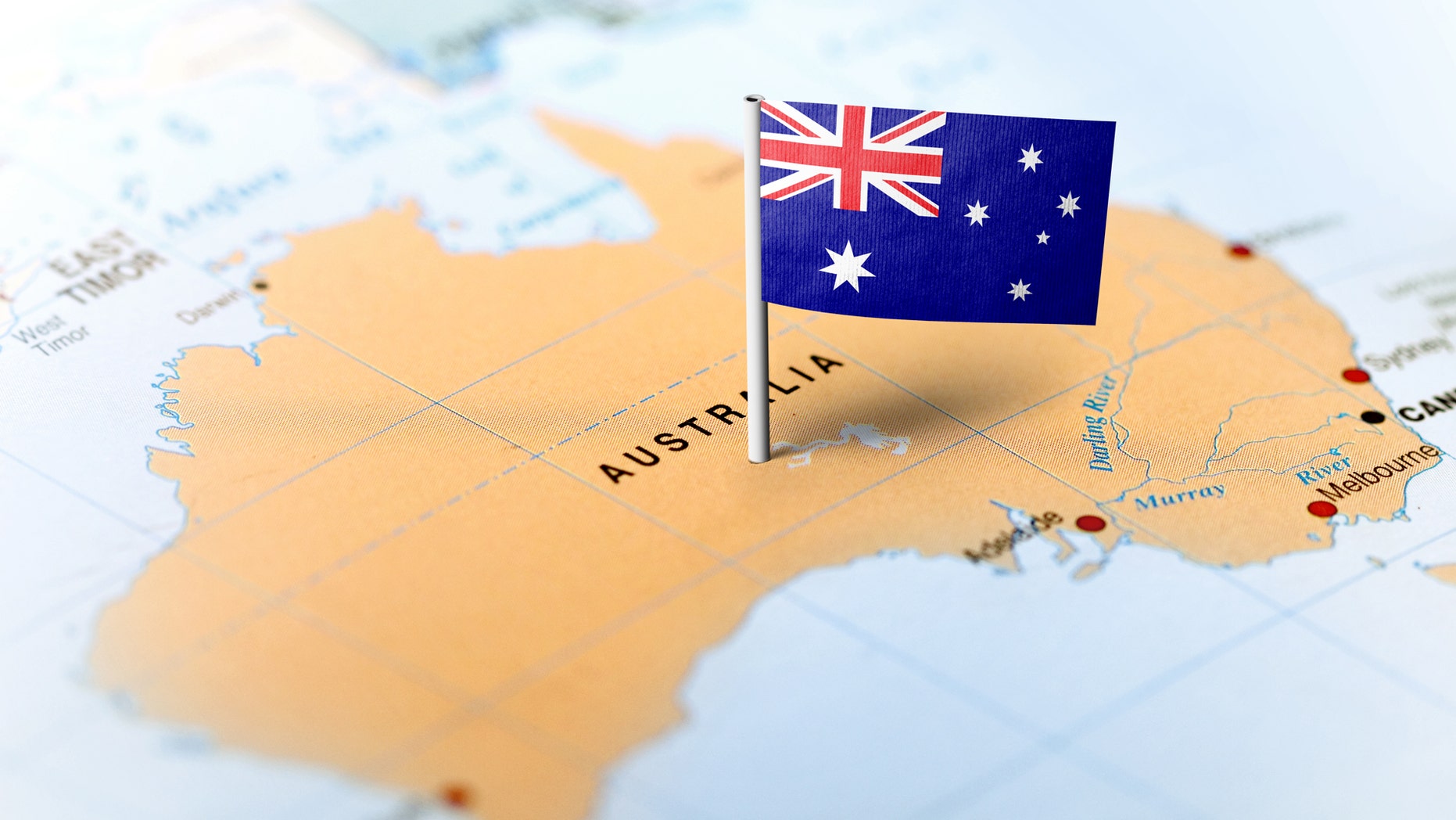 The flag of Australia pinned on the map. Horizontal orientation. Macro photography. (MarkRubens, iStock)