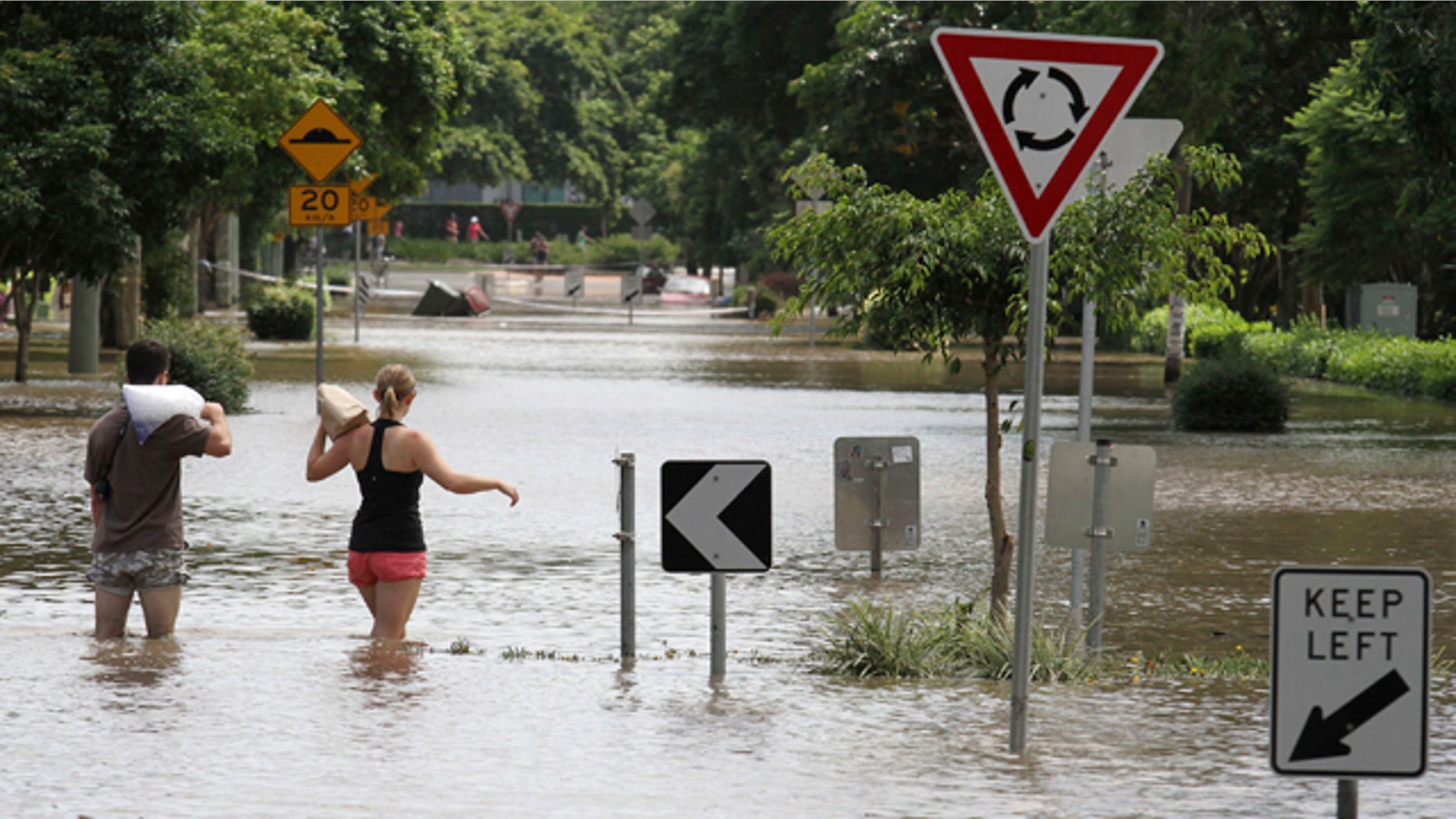 Jan. 13: Residents walk through floodwaters after getting ice and food to take to their flooded home in the suburb of New Farm in Brisbane, Australia.