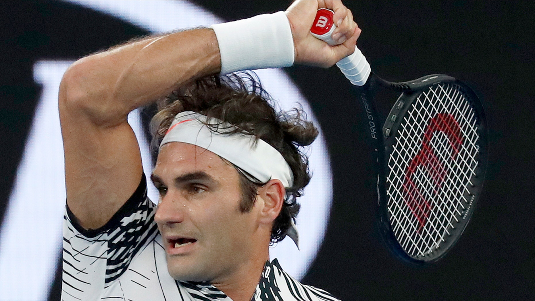 Switzerland's Roger Federer follows through on a forehand to Spain's Rafael Nadal during the men's singles final at the Australian Open tennis championships in Melbourne, Australia, Sunday, Jan. 29, 2017.