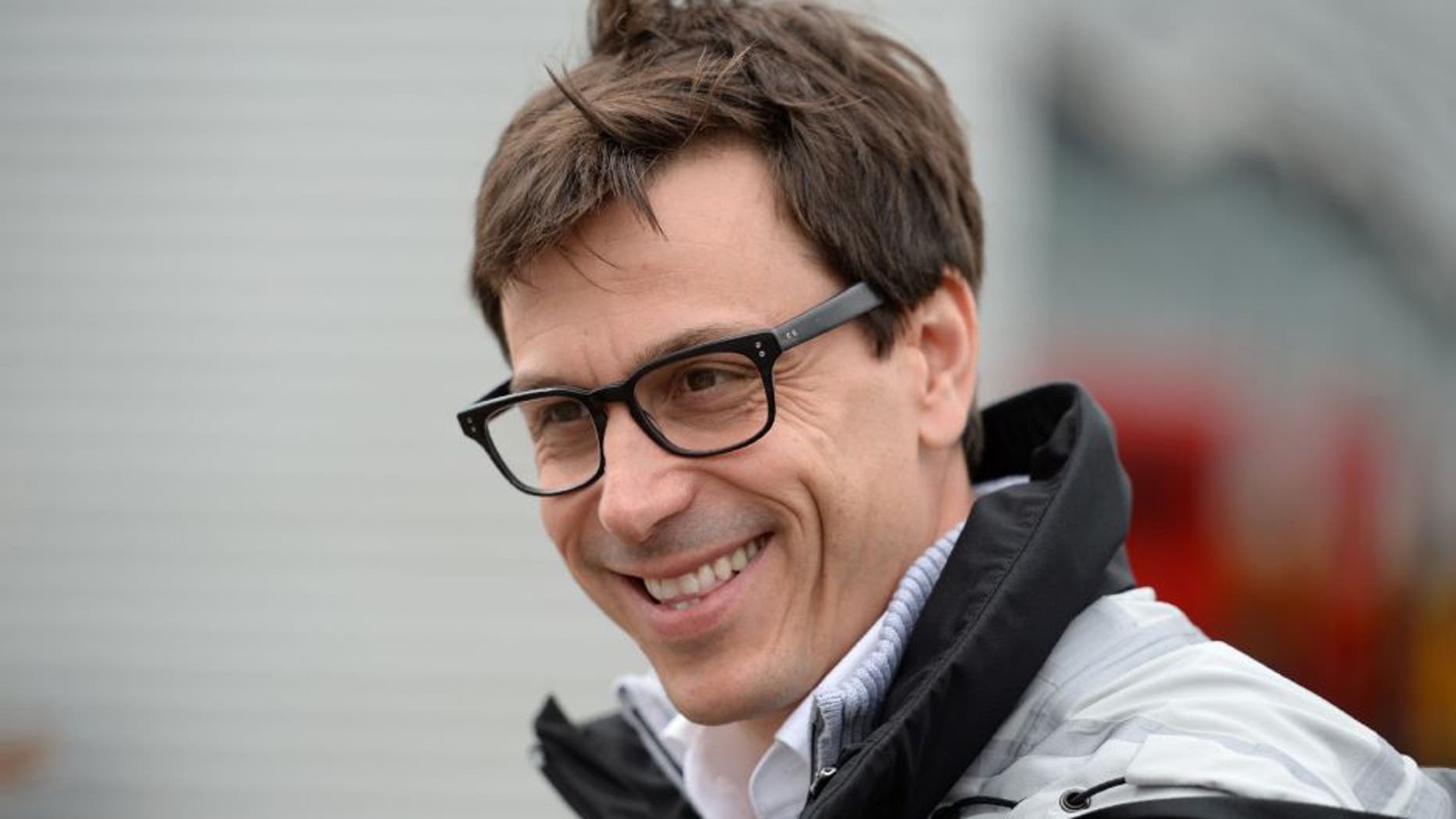Mercedes AMG Petronas F1 Team's team principal Toto Wolff reacts as he walks through the paddock ahead of the British Formula One Grand Prix at Silverstone motor racing circuit in Silverstone, central England, on July 10, 2016. Lewis Hamilton held his nerve to grab pole position ahead of Mercedes team-mate Nico Rosberg for Sunday's British Grand Prix with a spectacular lap in the final seconds of an intense qualifying session. / AFP / OLI SCARFF (Photo credit should read OLI SCARFF/AFP/Getty Images)