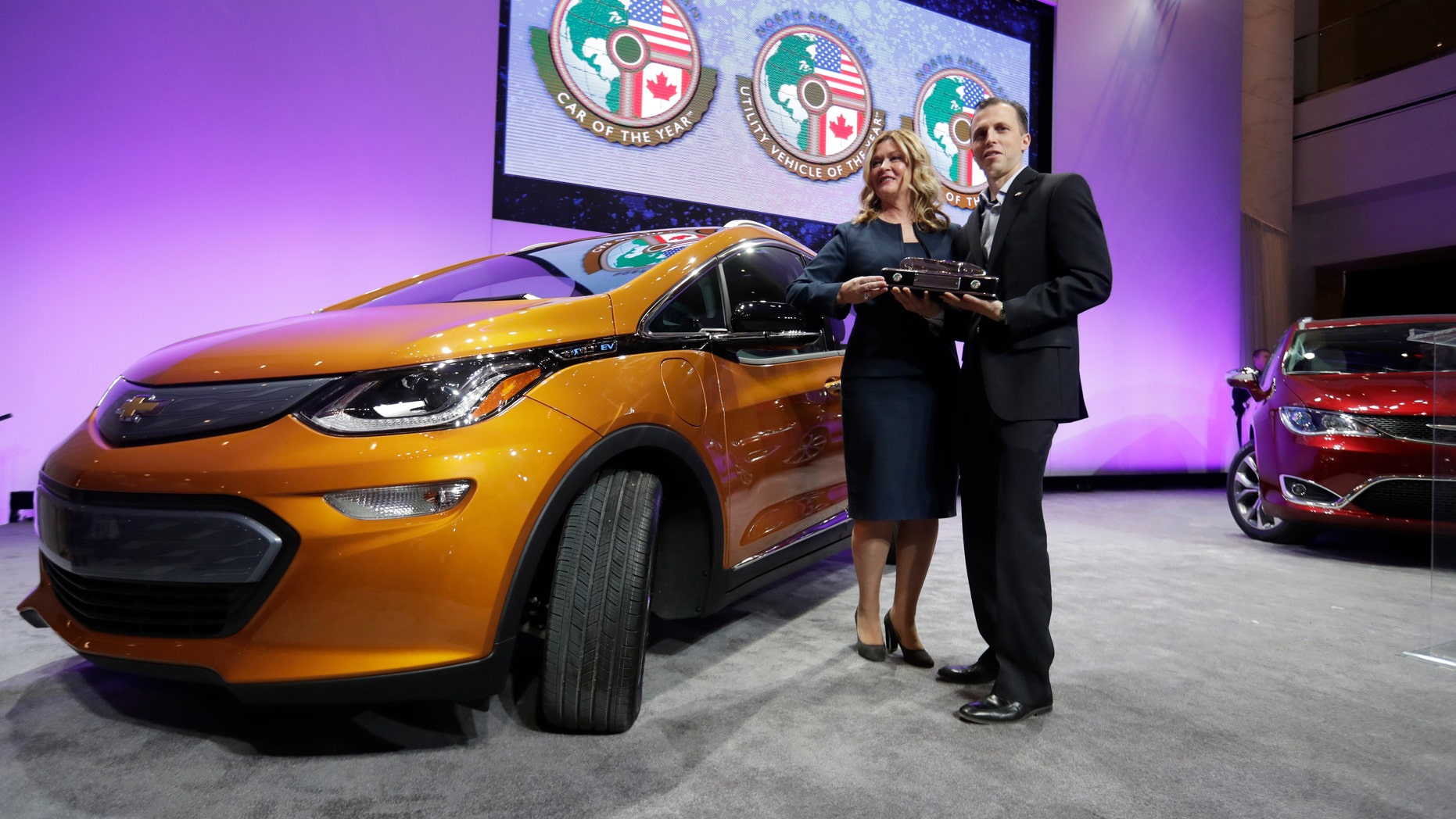 General Motors Executive Chief Engineer Autonomous & Electrified Vehicles and New Technology Pam Fletcher, left, and Bolt Chief Engineer Josh Tavel stand next to a Chevy Bolt after being named top car in the North America at the North American International Auto show, Monday, Jan. 9, 2017, in Detroit. (AP Photo/Carlos Osorio)