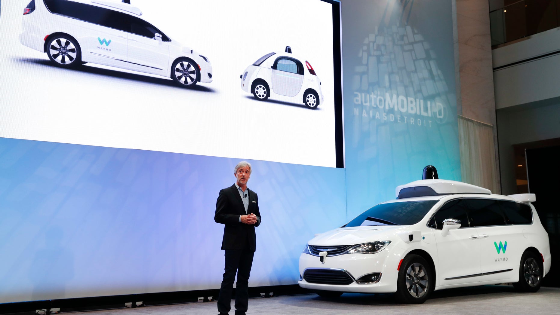 John Krafcik, CEO of Waymo Inc., the autonomous vehicle company created by Google's parent company, introduces a Chrysler Pacifica hybrid outfitted with Waymo's own suite of sensors and radar at the North American International Auto Show in Detroit, Sunday, Jan. 8, 2017. (AP Photo/Paul Sancya)