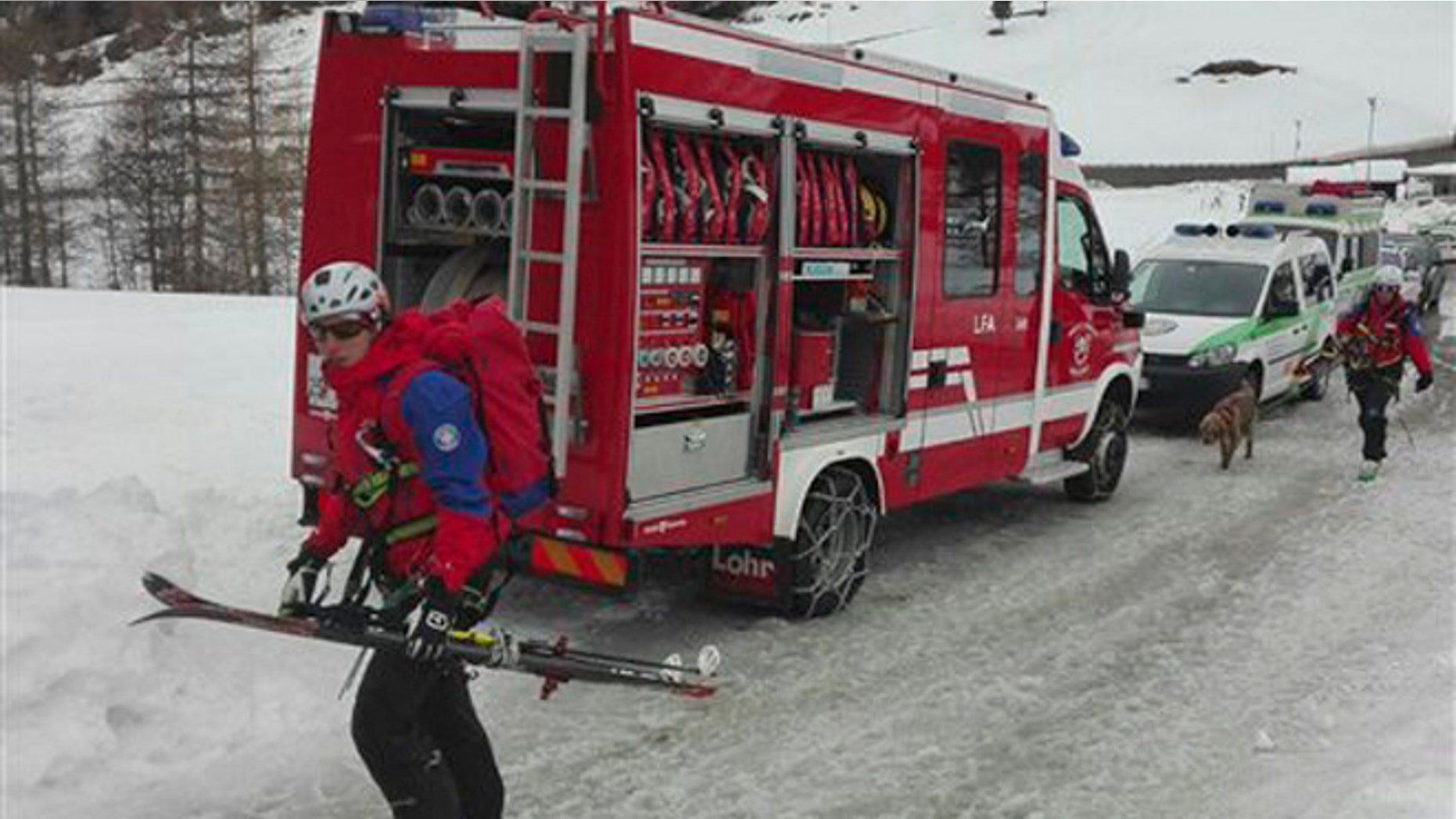 Rescuers prepare to board helicopters in Valle Aurina, in the Italian Alps, in order to reach the spot in Monte Nevoso where six backcountry skiers have died in an avalanche Saturday, March 12, 2016. (ANSA via AP Photo)