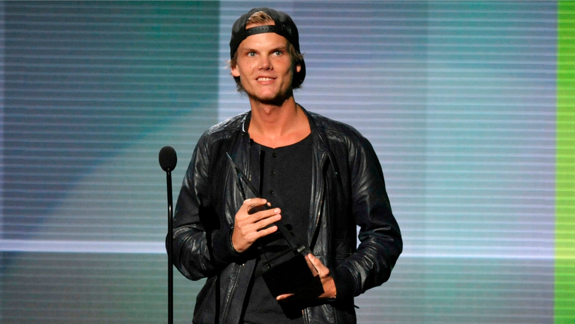 In this Nov. 24, 2013 file photo, Avicii accepts the award for favorite artist - electronic dance music at the American Music Awards in Los Angeles. Avicii’s family released a statement Monday, April 23, 2018, saying they “would like to thank you for the support and the loving words about our son and brother.” They say they are grateful for his fans around the world who loved his music. Swedish-born Avicii, whose name is Tim Bergling, was found dead, April 20, in Muscat, Oman.