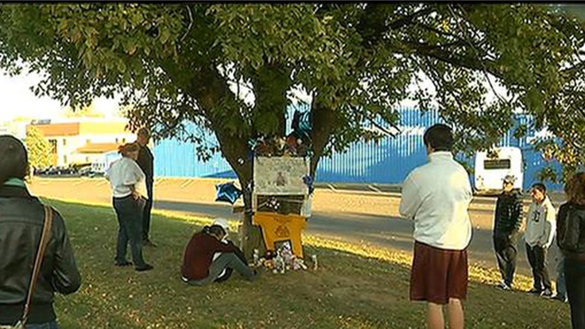 Oct. 27, 2013: Visitors gather around a memorial for Christopher Avlevo, who was killed in Philadelphia Saturday while trying to steer a pickup truck to safety after his stepfather blacked out behind the wheel.