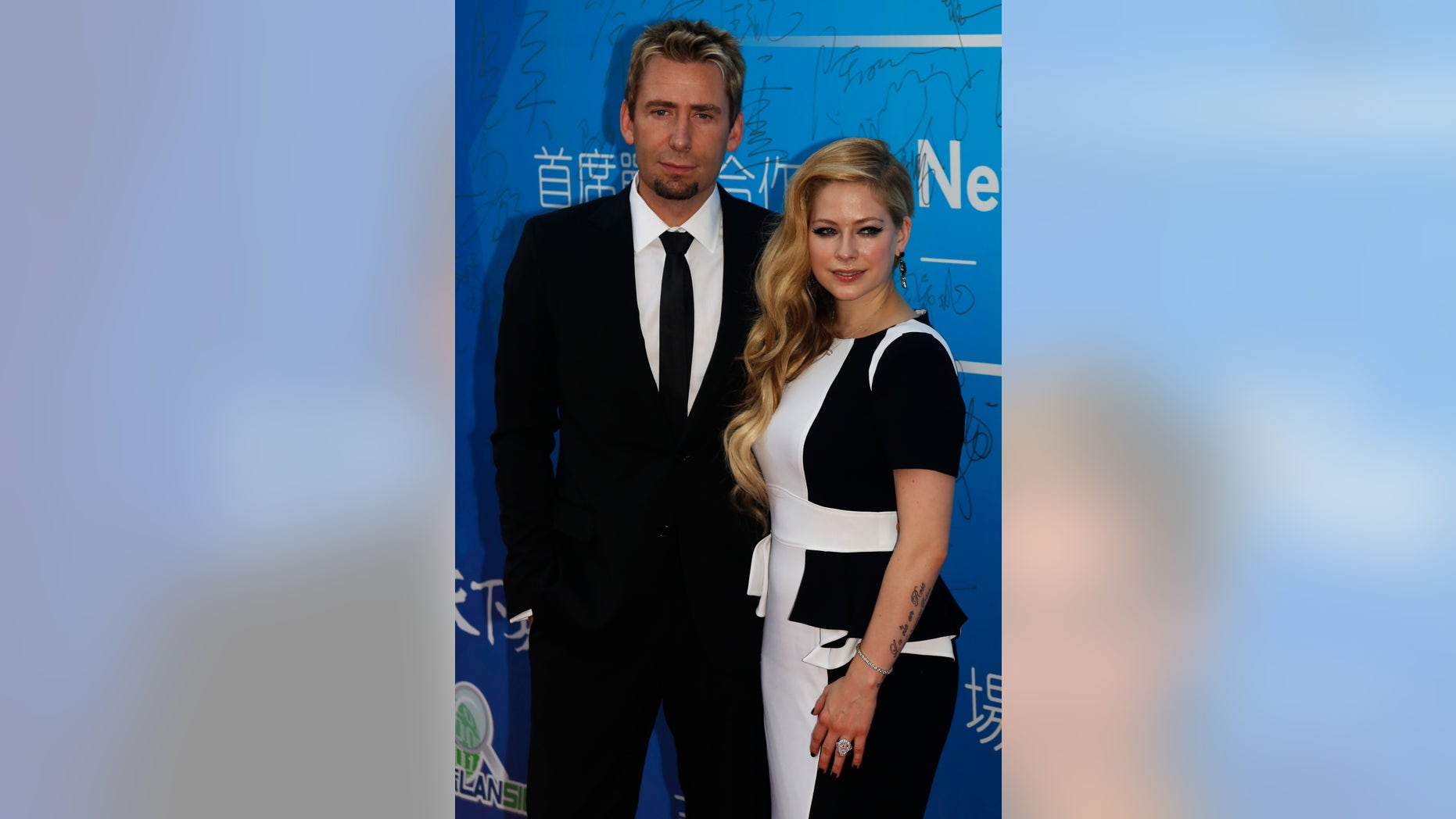 October 7, 2013. Canadian singer and songwriter Avril Lavigne and her husband Chad Kroeger pose on the red carpet at the Huading Awards ceremony in Macau.