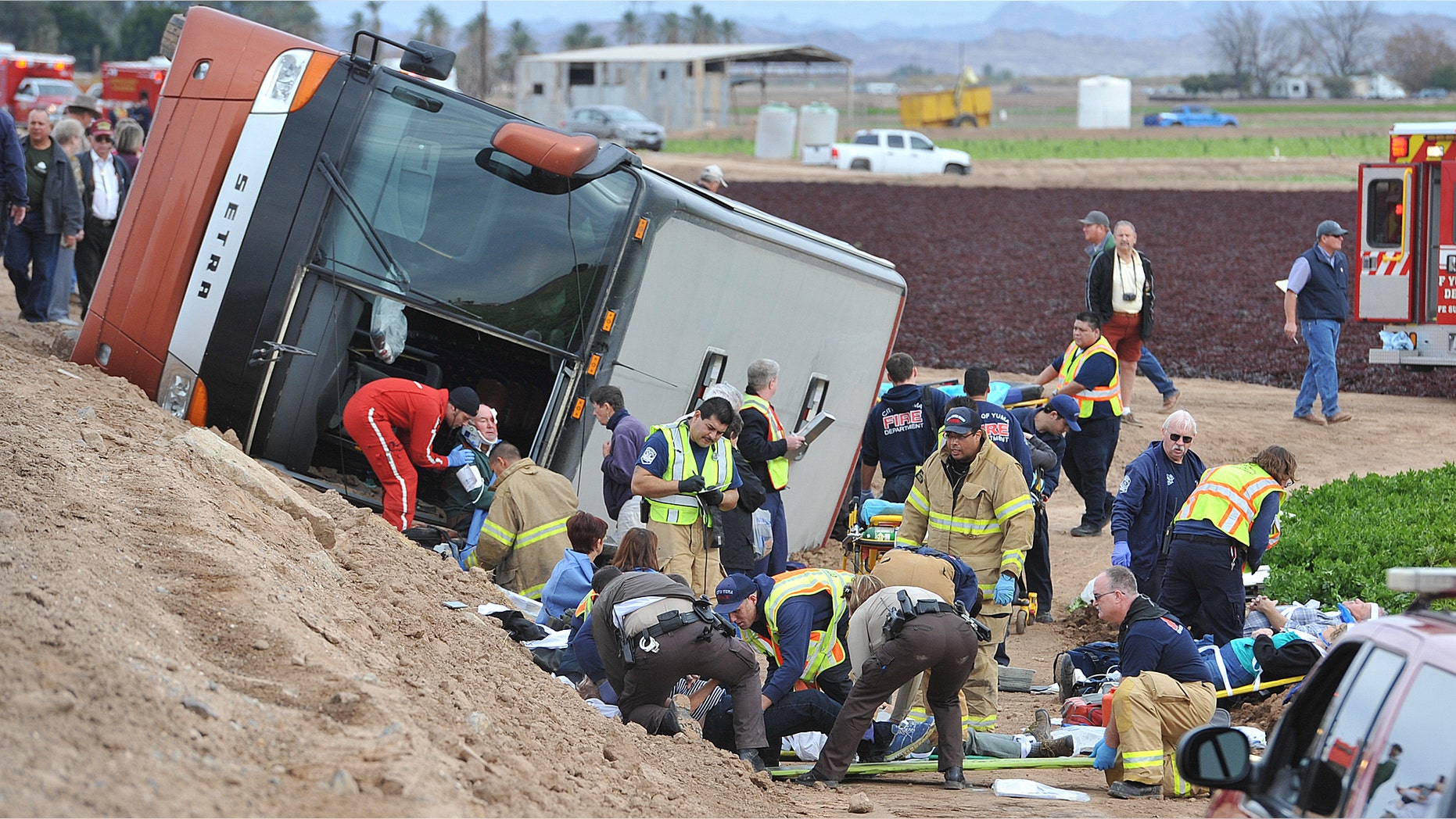 Jan. 8, 2015: Emergency personnel tend to victims of a tour bus crash on an agricultural sightseeing trip Thursday morning.
