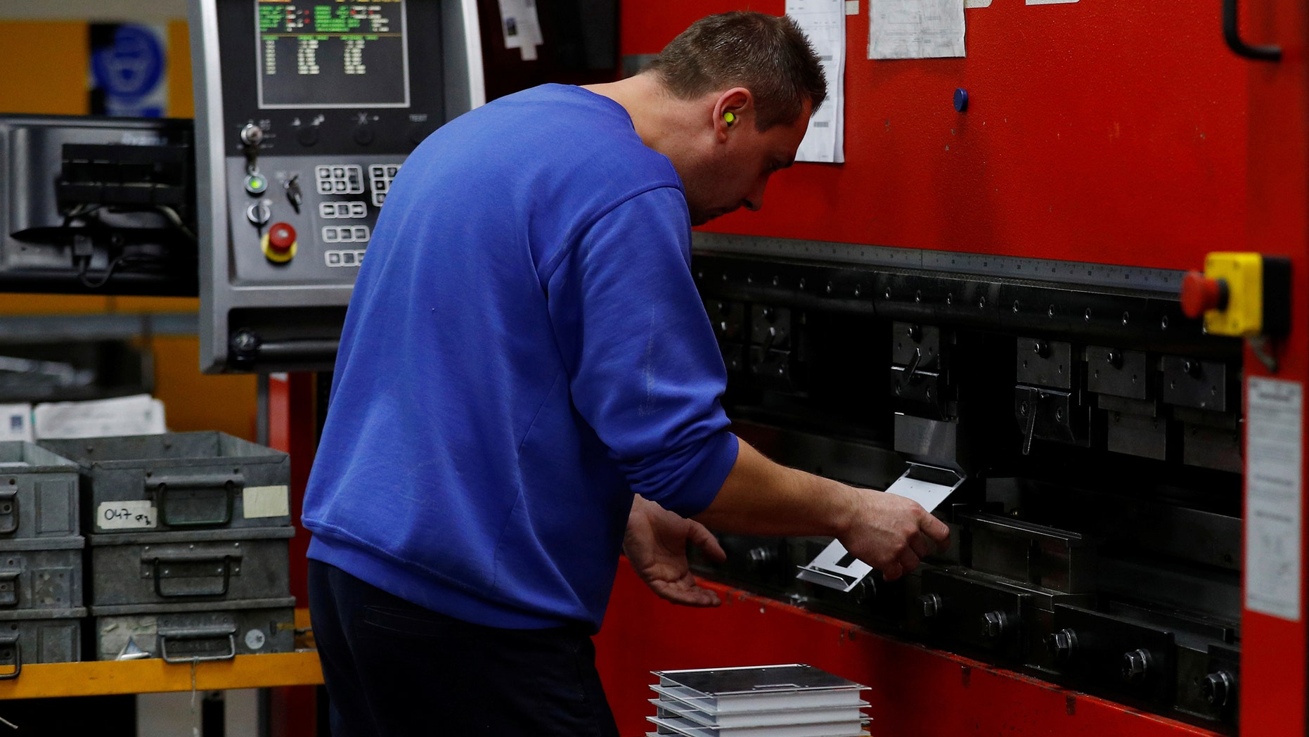 A worker folds pieces of steel on a press at the Mec Com Ltd factory near Stafford, central England December 15, 2016. Picture taken December 15, 2016. (REUTERS/Phil Noble)