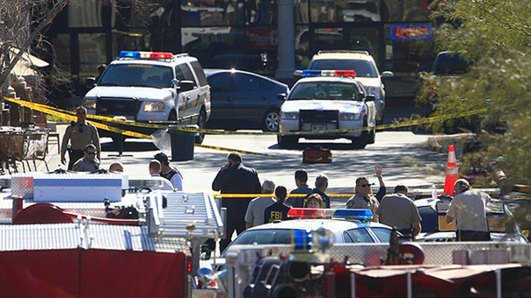 Jan. 8: Law enforcement personnel work a crime scene where U.S Representative Gabrielle Giffords (D-AZ) was shot along with others at a Safeway in Tucson, Arizona.