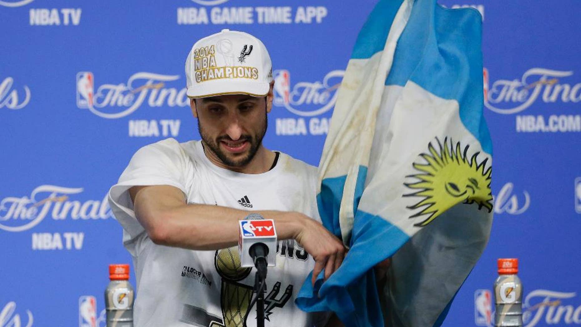 San Antonio Spurs guard Manu Ginobili arrives for a news conference after Game 5 of the NBA basketball finals against the Miami Heat on Sunday, June 15, 2014, in San Antonio. (AP Photo/Tony Gutierrez)