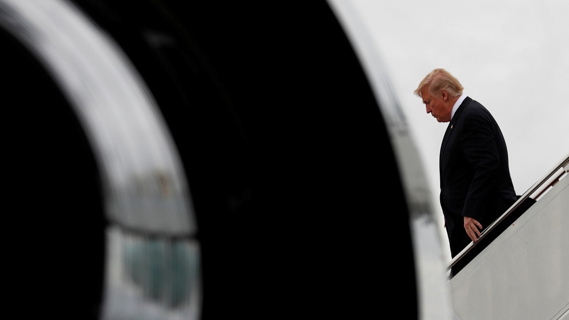President Donald Trump steps from Air Force One as he arrives in West Palm Beach, Florida, December 9, 2017.