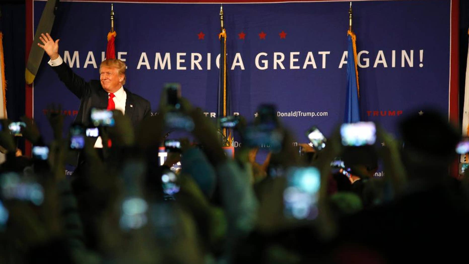 Republican presidential candidate, businessman Donald Trump, waves to supporters before his rally coinciding with Pearl Harbor Day at Patriots Point aboard the aircraft carrier USS Yorktown in Mt. Pleasant, S.C., Monday, Dec. 7, 2015. (AP Photo/Mic Smith)