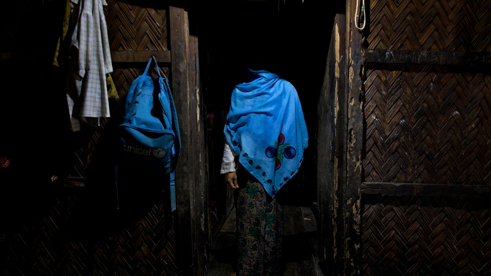FILE - In this Sept. 15, 2013 photo, a woman who claims she was raped by Myanmar security forces stands in her home in Ba Gong Nar village, Maungdaw, northern Rakhine state, Myanmar. Myanmar's transition to democracy following five decades of brutal military rule has won widespread international praise, but rights’ groups say little has changed in resource-rich border areas, where the army continues to grapple with stubborn ethnic insurgencies. As in the past, the use of sexual violence against civilians is widespread and systematic, said Tin Tin Nyo, general secretary of the Women's League of Burma. (AP Photo/Gemunu Amarasinghe, File)