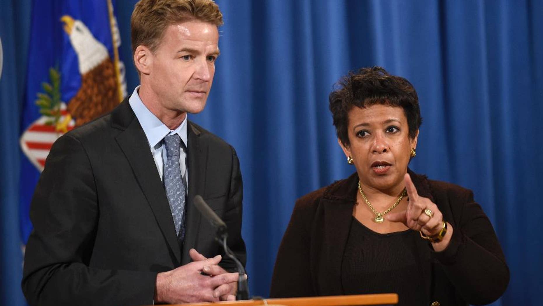 FILE - In this Dec. 7, 2015 file photo, U.S. Attorney General Loretta Lynch, right, and U.S. Attorney in Chicago Zachary Fardon speak at a news conference at the Justice Department in Washington about an investigation of the Chicago Police Department. Federal officials are meeting with Chicago police Wednesday, Dec. 16, 2015, as the U.S. Department of Justice launches a civil rights probe triggered by the shooting death of a black teenager by a white police officer. (AP Photo/Susan Walsh, File)