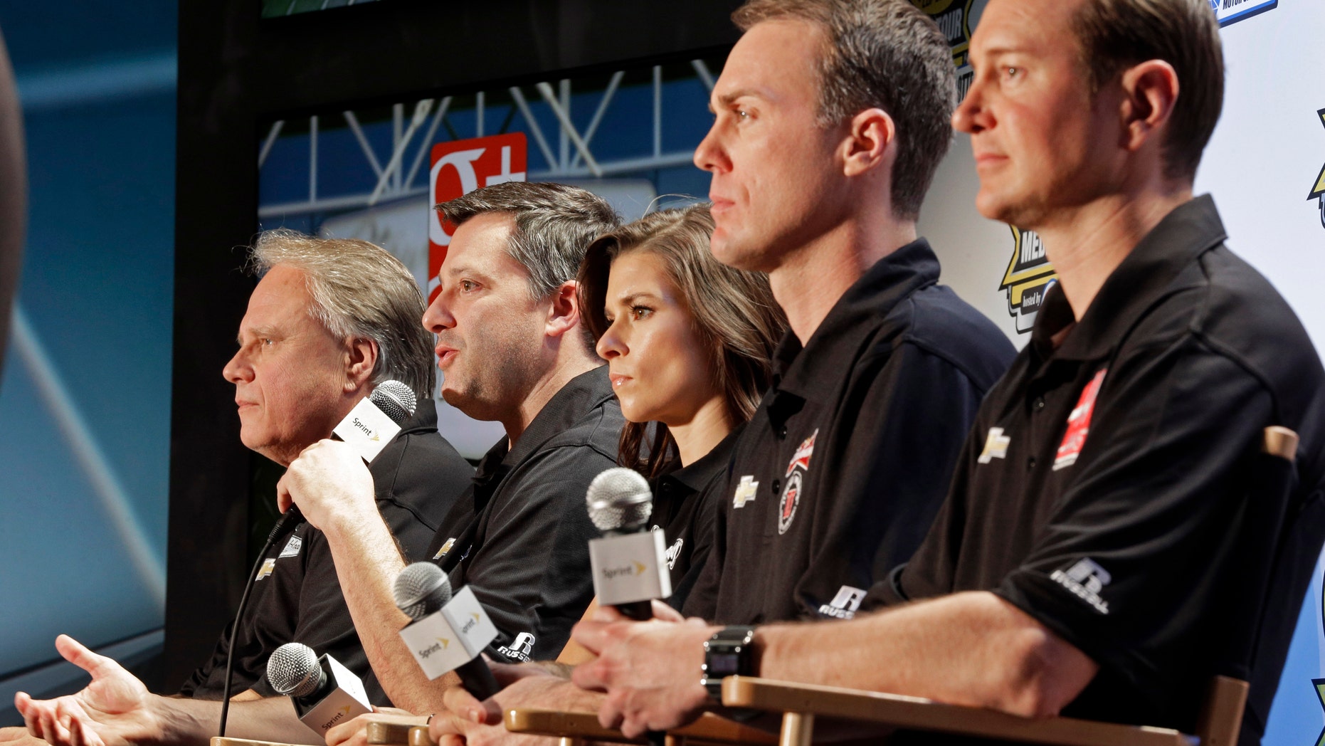 Driver/owner Tony Stewart, second from left, speaks as co-owner Gene Haas, left, and drivers, from right, Kurt Busch, Kevin Harvick and Danica Patrick listen during a news conference at the NASCAR Sprint Cup auto racing Media Tour in Charlotte, N.C., Monday, Jan. 27, 2014. (AP Photo/Chuck Burton)