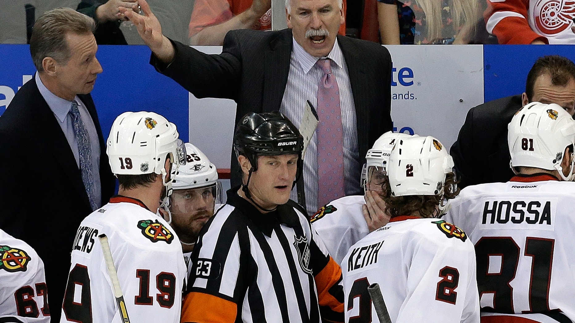 Chicago Blackhawks head coach Joel Quenneville yells at referee Brad Watson (23) during the third period of an NHL hockey Stanley Cup playoffs Western Conference semifinal game in Detroit, Monday, May 20, 2013. (AP Photo/Paul Sancya)