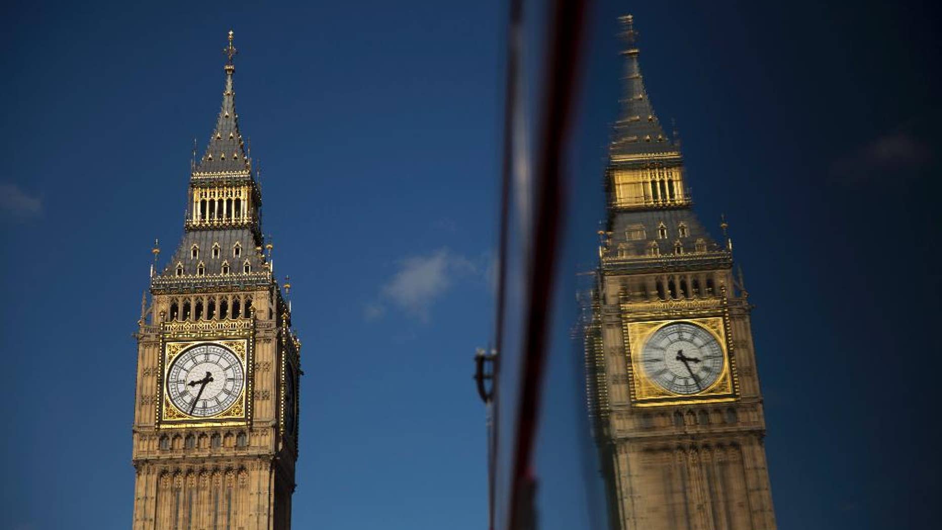 Elizabeth Tower, which houses the Big Ben bell, reflected in a bus window in London Tuesday.