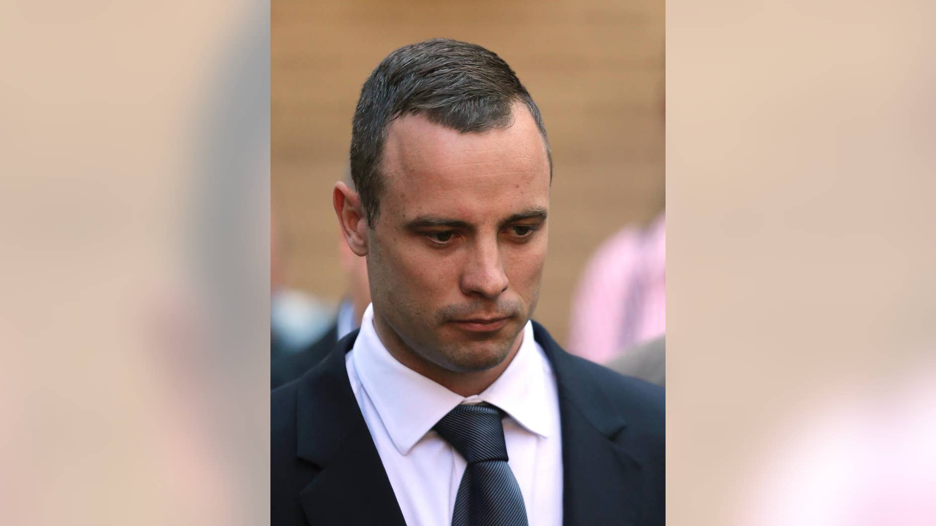 Oscar Pistorius leaves the high court in Pretoria, South Africa, Wednesday, May 14, 2014. The judge overseeing the murder trial of Pistorius on Wednesday ordered the double-amputee athlete to undergo psychiatric tests, meaning that the trial proceedings will be delayed. (AP Photo/Themba Hadebe)