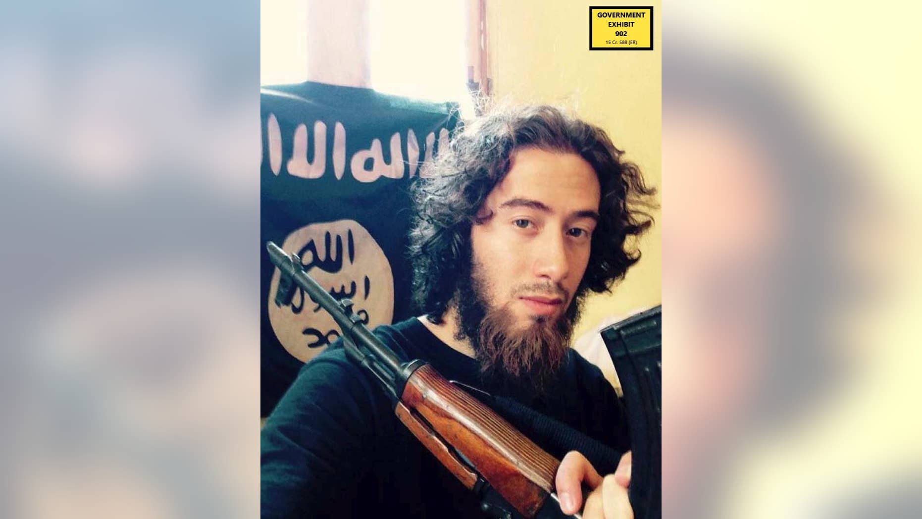 In this undated photo provided by the United States Attorney for the Southern District of New York, Samy el-Goarany poses for a photo with a weapon and the Islamic State group flag. Prosecutors showed this photo of Samy el-Goarany in federal court Tuesday, Jan. 17, 2017, during the trail of Ahmed Mohammed el-Gammal who is accused of helping Samy el-Goarany reach Syria where he trained with the Islamic State group before he was killed. The photo was shown while Samy el-Goarany's brother, Tarek el-Goarany, was testifying. (U.S. Attorney's Office for the Southern Distirct of New York via AP)