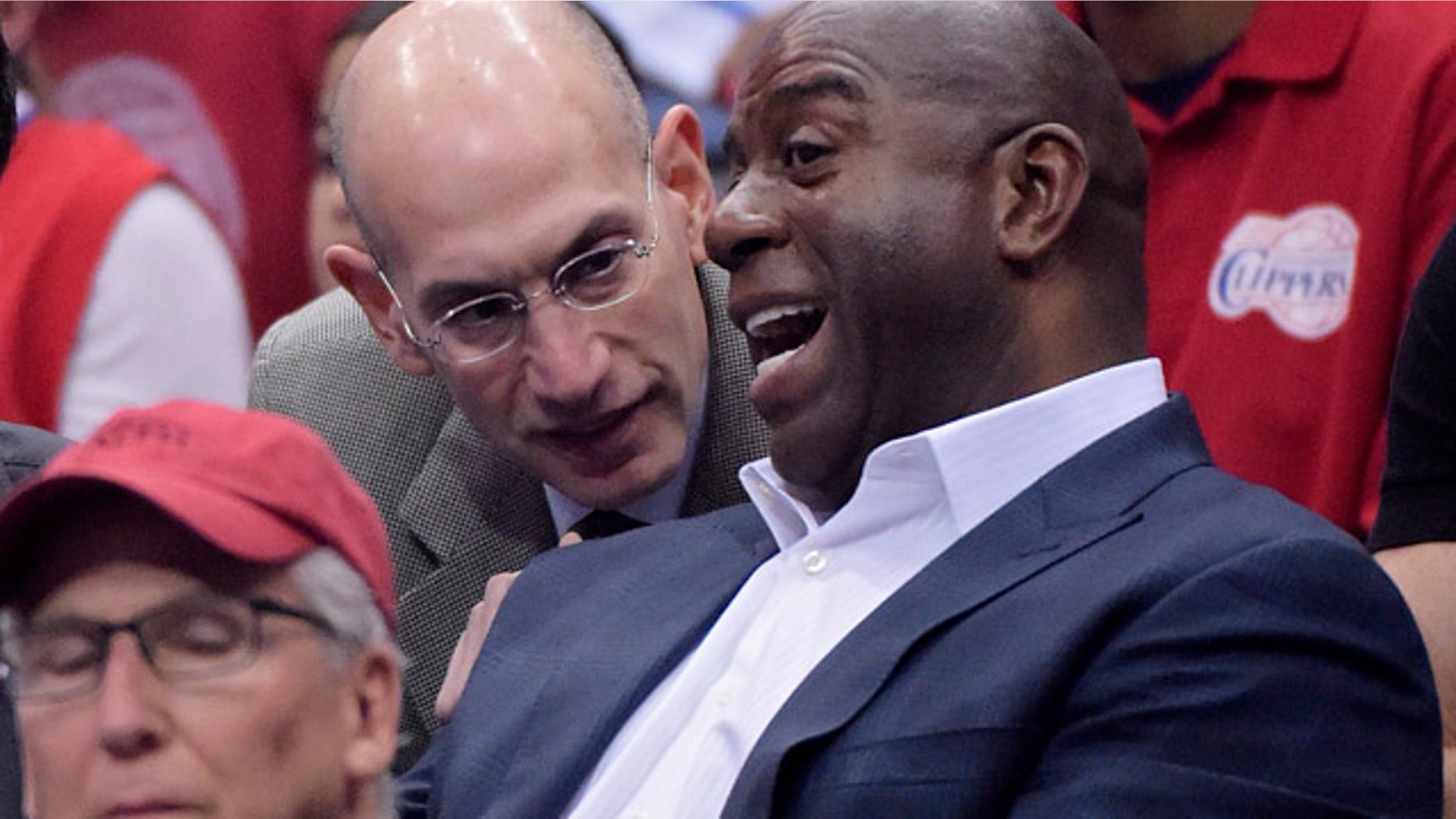 May 11, 2014: NBA Commissioner Adam Silver, left, talks with Magic Johnson as they watch the Los Angeles Clippers play the Oklahoma City Thunder in the first half of Game 4 of the Western Conference semifinal NBA basketball playoff series in Los Angeles. (AP Photo/Mark J. Terrill)