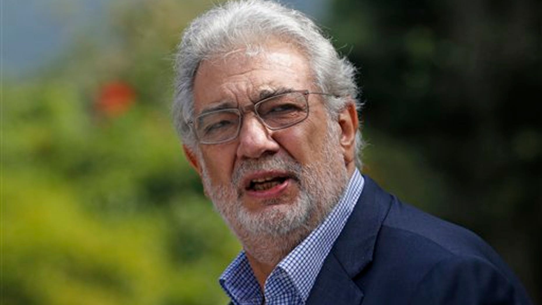 Tenor Placido Domingo gestures after a press conference in Rio de Janeiro, Brazil, Thursday, July 3, 2014. For Placido Domingo, opera and soccer go hand in hand. The Spanish tenor has performed during almost every World Cup since 1990 and plans a July 11 concert in Rio de Janeiro, just two days before the city hosts the final game. (AP Photo/Silvia Izquierdo)