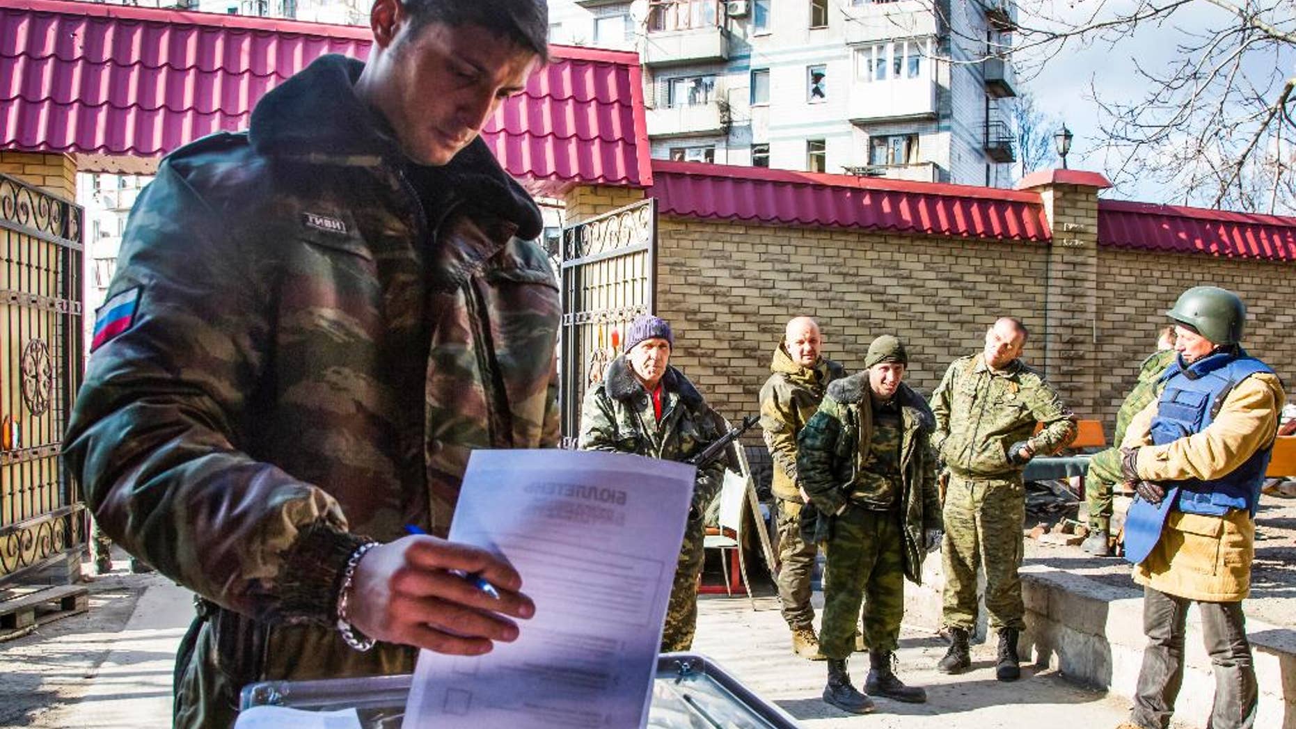 FILE - In this Nov. 2, 2014, file photo, a Pro-Russian rebel commander with the nom de guerre Givi casts his ballot during supreme council and presidential elections on the front line near Donetsk airport in the city of Donetsk, eastern Ukraine. Rebels' Donets News Agency said on Wednesday, Feb. 8, 2017, that Mikhail Tolstykh, better known under his nom de guerre Givi, died early Wednesday morning in what it described as a terrorist attack. Several Russian media outlets said 35-year old Tolstykh died in an explosion in his office. (AP Photo/Dmitry Lovetsky, file)
