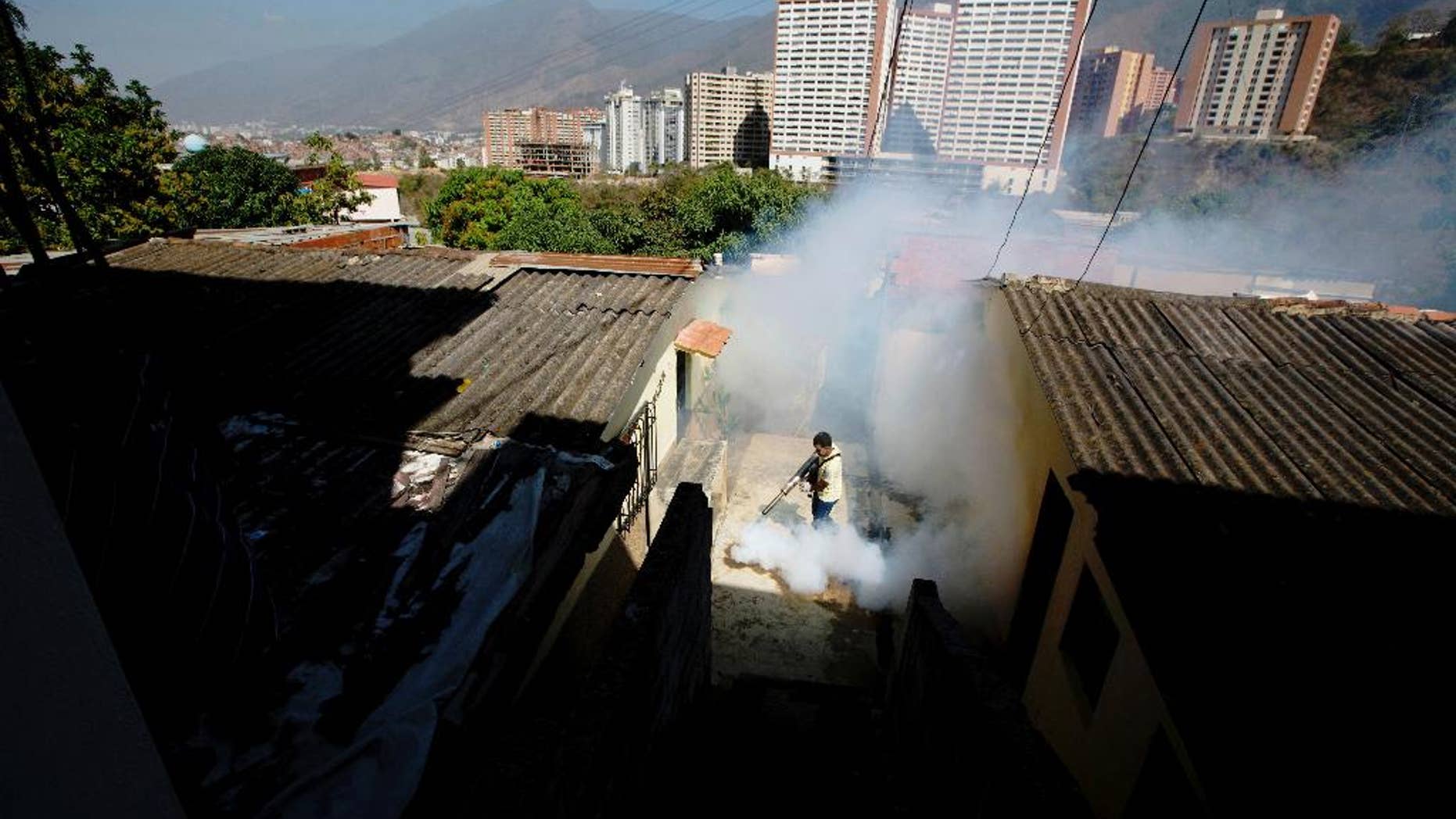 Feb. 1, 2016: In this file photo, a Sucre municipality worker fumigates for Aedes aegypti mosquitoes that transmit the Zika virus in the Petare neighborhood of Caracas, Venezuela.