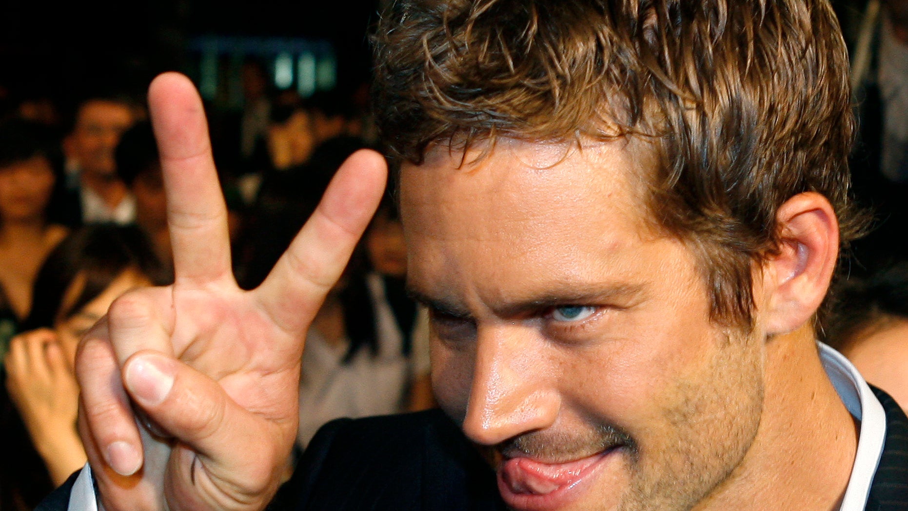 April 15, 2009. Paul Walker gestures to a fan during the premiere of the movie "Fast and Furious 4" in Taipei.
