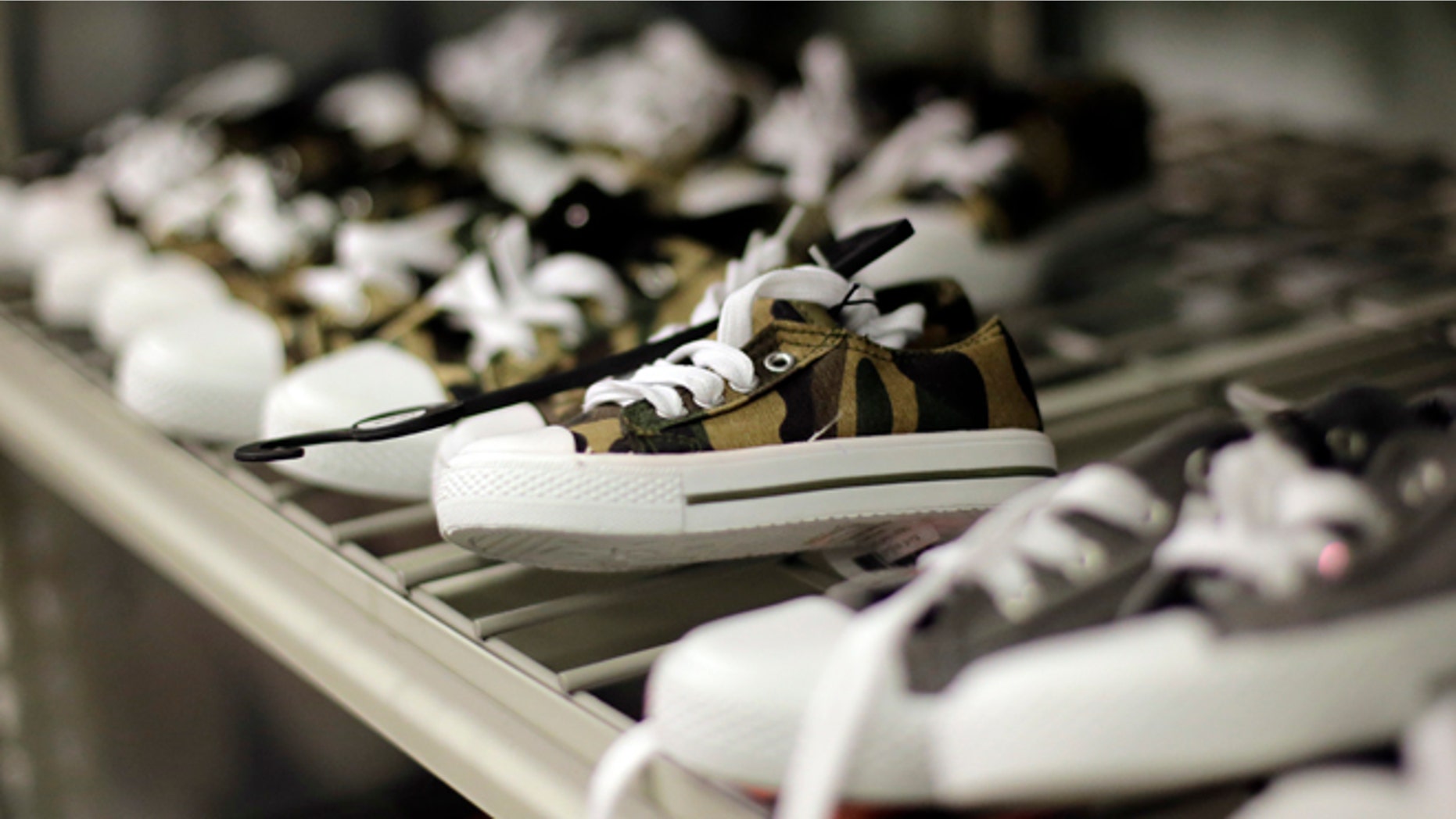 This Thursday, July 31, 2014 photo shows new children's shoes stored on a shelf at the Karnes County Residential Center in Karnes City, Texas. On Tuesday, April 14, 2015, a Honduran mother who was recently released from the facility with her 2-year-old son said immigrant children at the federal detention facility are acting depressed after months of regimentation and confinement. (AP Photo/Eric Gay)