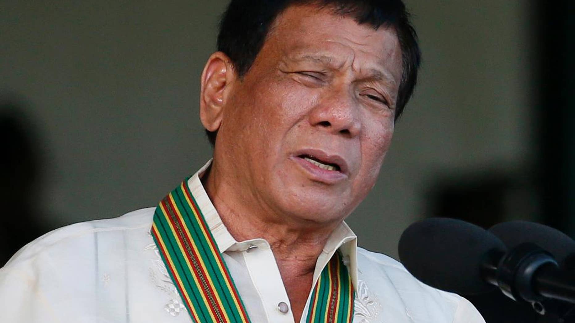 FILE - In this Tuesday, April 4, 2017 file photo, Philippine President Rodrigo Duterte gestures while addressing army troopers during the 120th anniversary celebration of the Philippine Army at Fort Bonifacio in suburban Taguig city, east of Manila, Philippines. Results of an independent poll released Wednesday, April 5 showed a drop in the number of Filipinos who trust President Rodrigo Duterte, although he was still considered trustworthy by three-quarters of the respondents despite an impeachment complaint pending against him. (AP Photo/Bullit Marquez, File)
