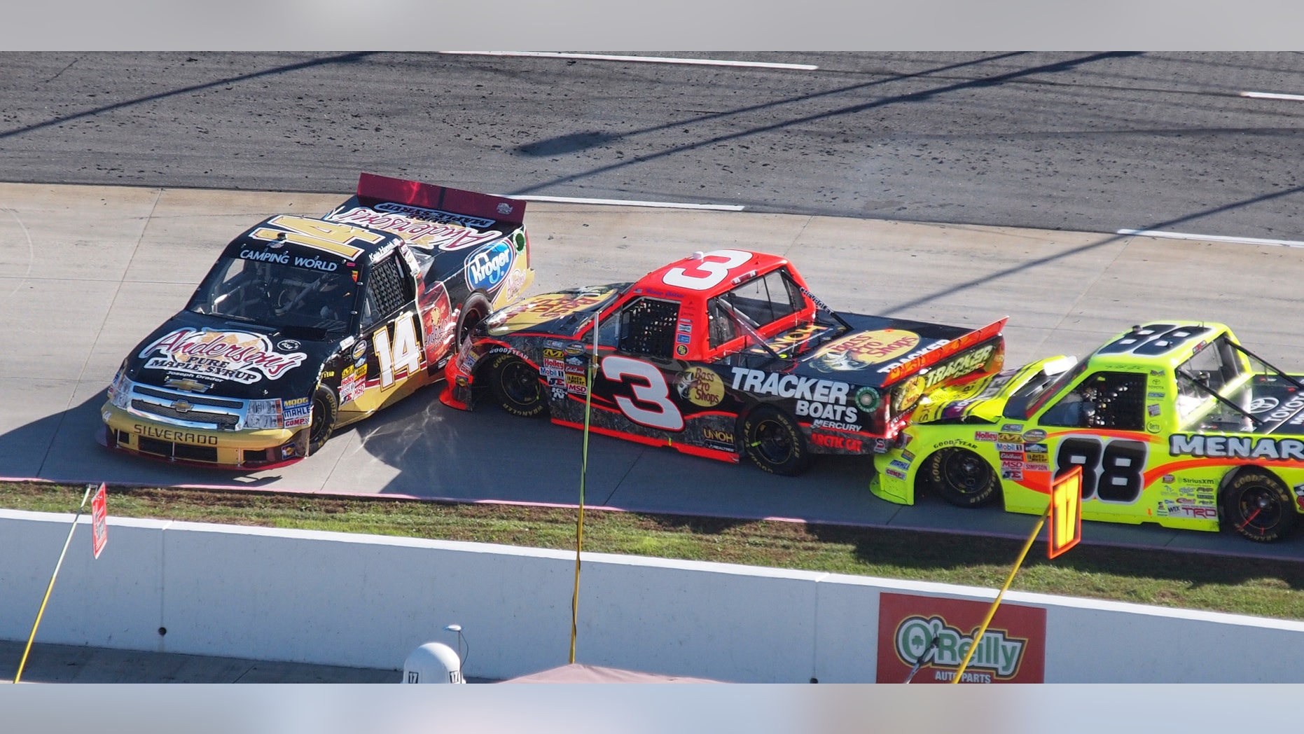 Kevin Harvick (14) spins out in front of Ty Dillon (3) and Matt Crafton (88) during the NASCAR Truck Series truck race at Martinsville Speedway in Martinsville, Va., Saturday, Oct. 26, 2013. (AP Photo/Steve Sheppard)