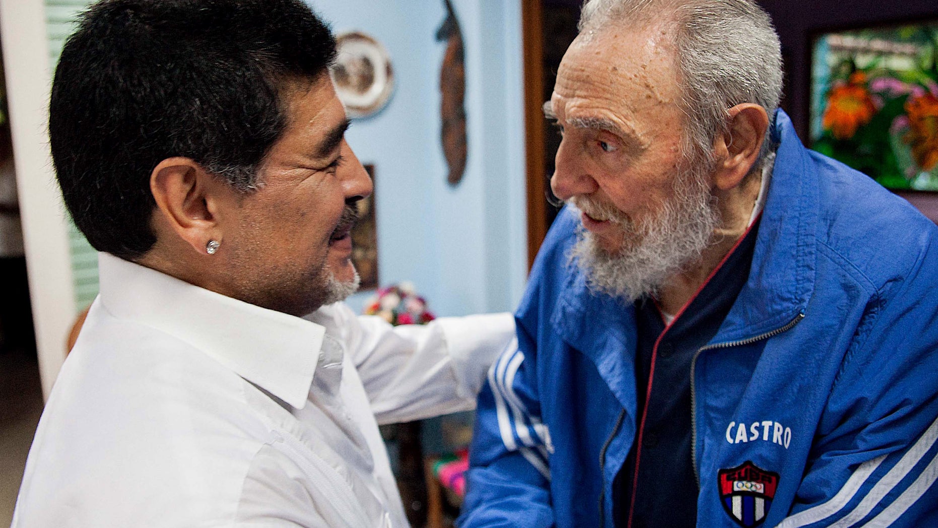 In this picture image released by Cuba's state newspaper Granma on Monday April 15, 2013, Cuba's Fidel Castro shakes hands with former soccer star Diego Maradona in Havana, Cuba, Saturday April 13, 2013. . (AP Photo/Alex Castro, Granma)