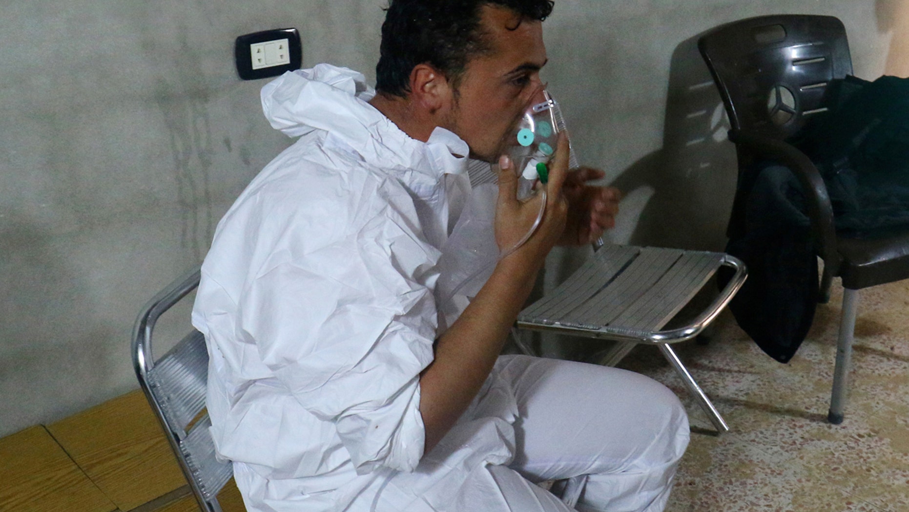 APRIL 4: man breathes through an oxygen mask, after what rescue workers described as a suspected gas attack in the town of Khan Sheikhoun.