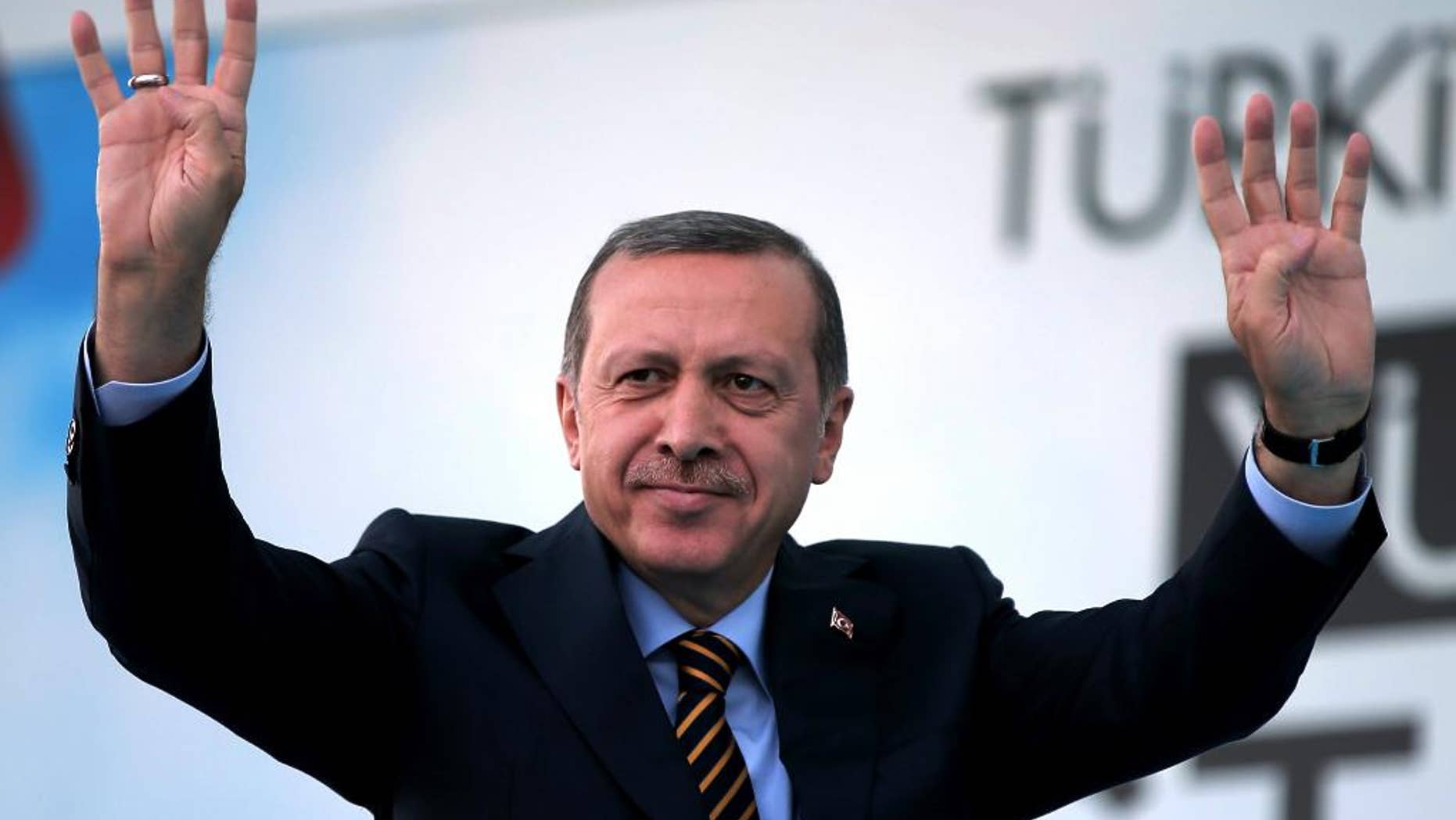 Turkish Prime Minister and presidential candidate of the ruling party in the August election, Recep Tayyip Erdogan waves to his supporters in Istanbul, Turkey, Friday July 25, 2014. (AP Photo/Emrah Gurel)