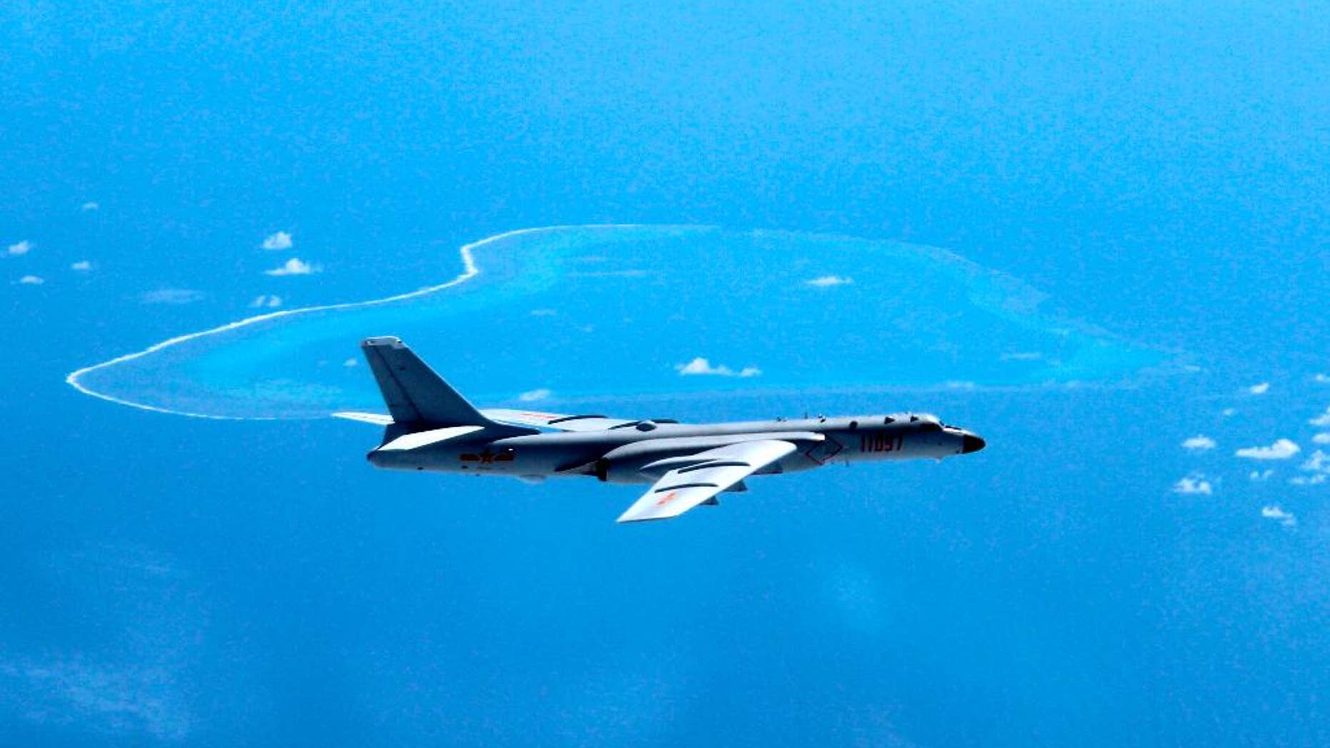 FILE - In this undated file photo released by Xinhua News Agency, a Chinese H-6K bomber patrols the islands and reefs in the South China Sea. Chinese planes and ships held war games in the Sea of Japan last week, the military said in a statement on its website late Saturday, Aug. 20, 2016, during which Beijing displayed its latest-generation frigate Jingzhou and destroyer Xi'an at a time of bitter territorial disputes with Asian neighbors. The ministry said aircraft were guided to their targets with the aid of early warning planes. Other types of aircraft involved weren't identified, although China has been touting the capabilities of its latest-generation long-range H-6K strategic bomber equipped with the DH-20 land-attack cruise missile, giving it the ability to hit targets as far away as Australia. (Liu Rui/Xinhua via AP, File)