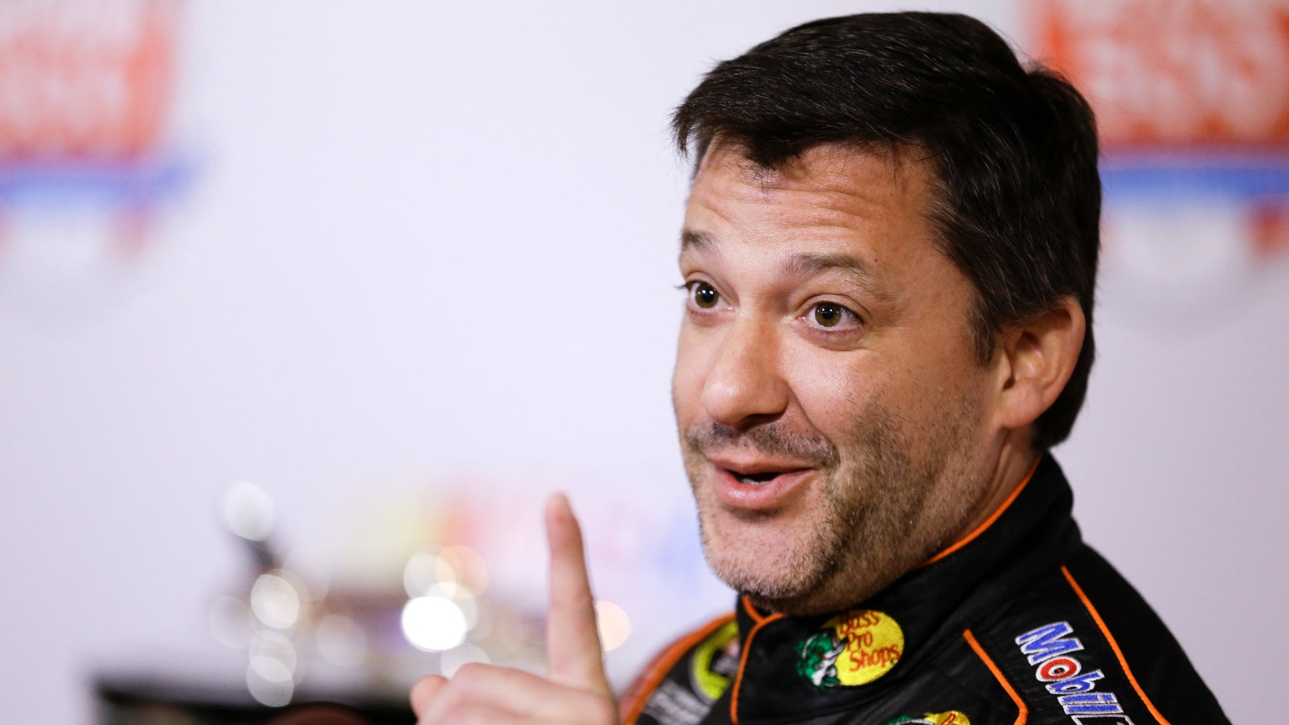 Tony Stewart jokes with members of the media during NASCAR auto racing media day at Daytona International Speedway in Daytona Beach, Fla., Thursday, Feb. 13, 2014. (AP Photo/John Raoux)