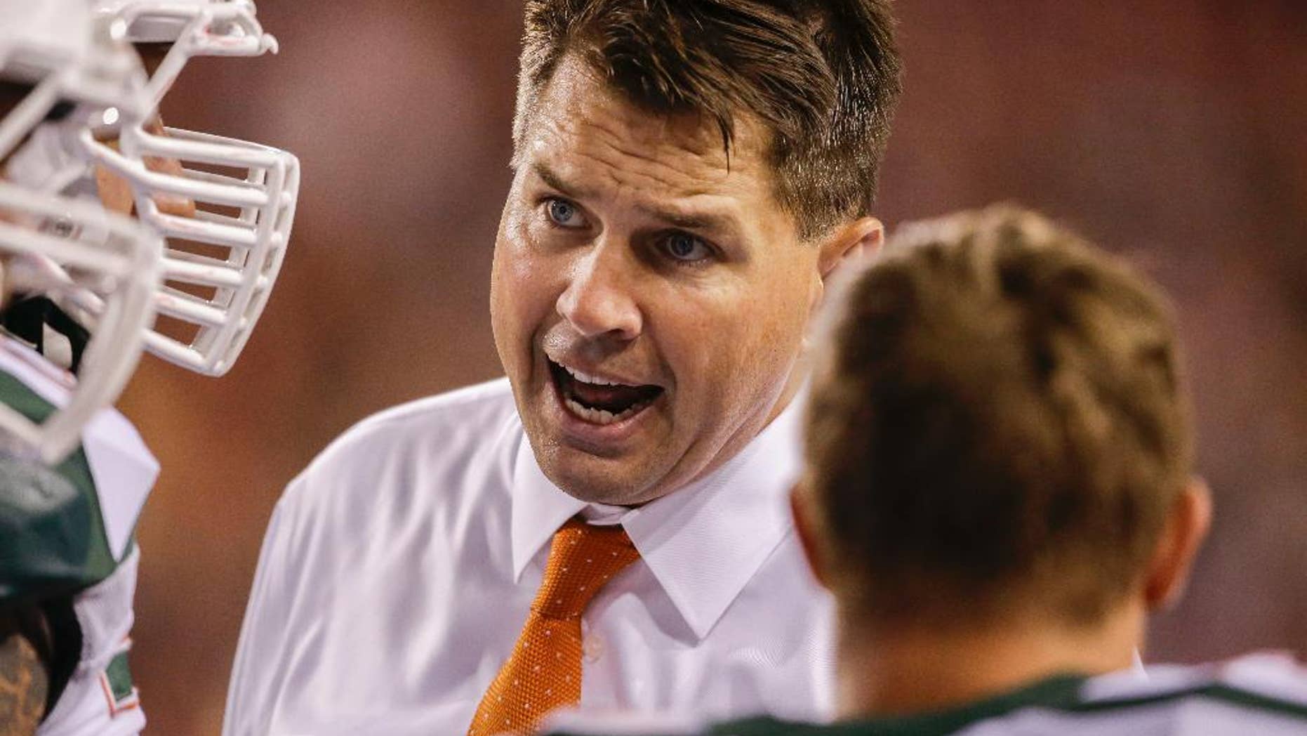Miami coach Al Golden talks to an unidentified player in the second half of an NCAA college football game against Nebraska in Lincoln, Neb., Saturday, Sept. 20, 2014. Nebraska won 41-31. (AP Photo/Nati Harnik)