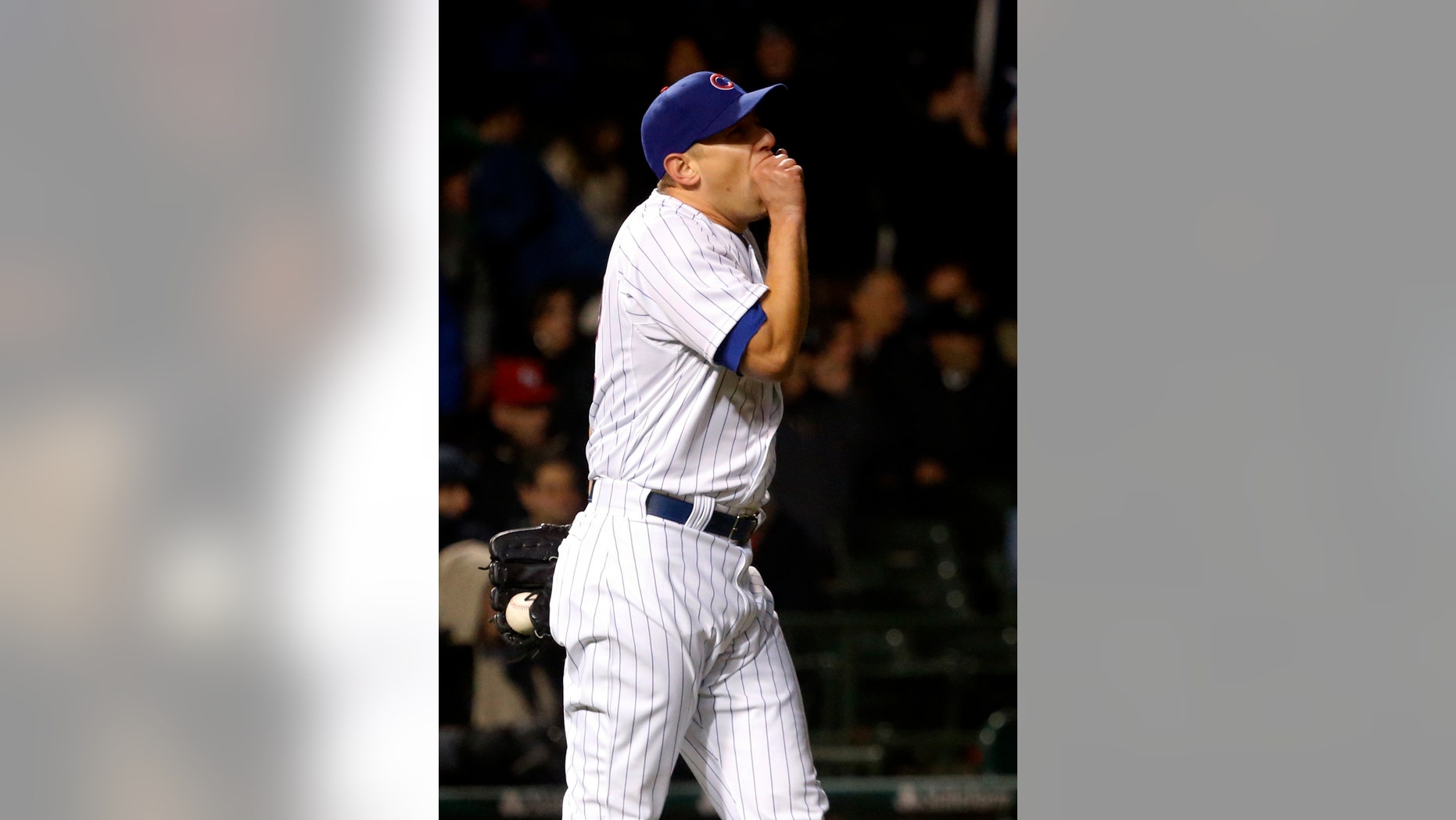 Chicago Cubs relief pitcher Shawn Camp reacts after giving up a two-run home run to Texas Rangers' Adrian Beltre, also scoring Elvis Andrus, during the eighth inning of a interleague baseball game, Tuesday, April 16 2013, in Chicago. (AP Photo/Charles Rex Arbogast)