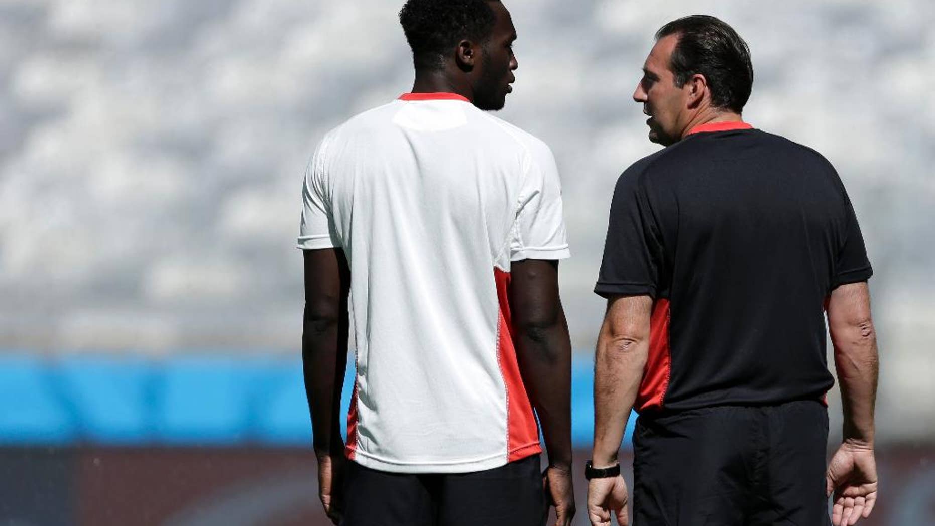 Belgium’s Romelu Lukaku and head coach Marc Wilmots talk at the start of a training session at the Mineirao Stadium in Belo Horizonte, Brazil, Monday, June 16, 2014. Belgium will play in group H of the Brazil 2014 soccer World Cup. (AP Photo/Bruno Magalhaes)