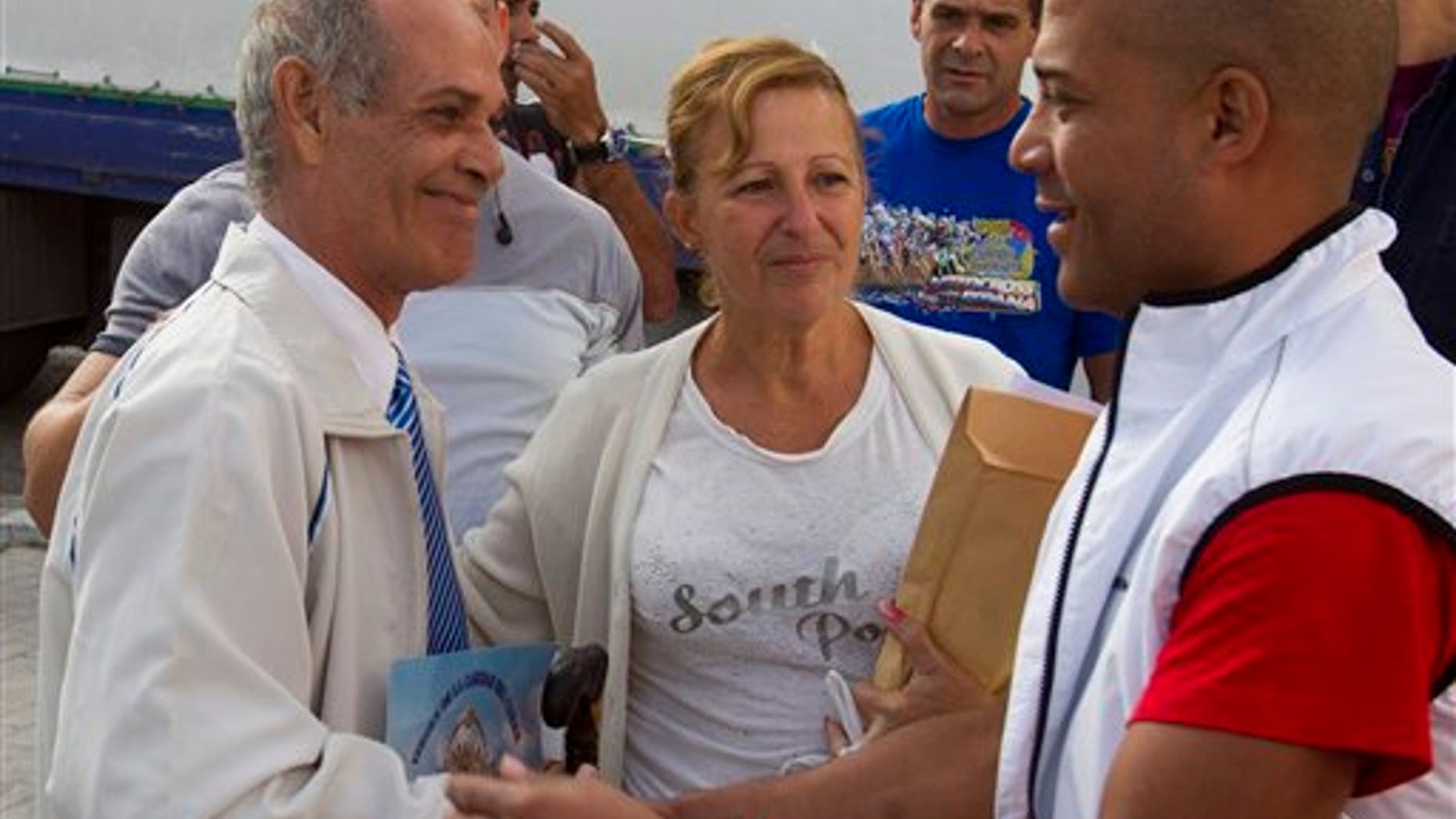 Freed Cuban prisoner Orlando Fundora Alvarez, left and his wife Yolanda, centre are greeted by other unidentified Cubans after arriving at a hostel in Madrid Friday April 8, 2011. A total of 37 former Cuban political prisoners and more than 200 relatives arrived Friday in Madrid in the largest such exodus since Spain started accepting such people last summer.Cuba has freed 75 dissidents rounded up in 2003, under an agreement reached between Cuban President Raul Castro and Havana Cardinal Jaime Ortega. Spain facilitated that accord. (AP Photo/Paul White)