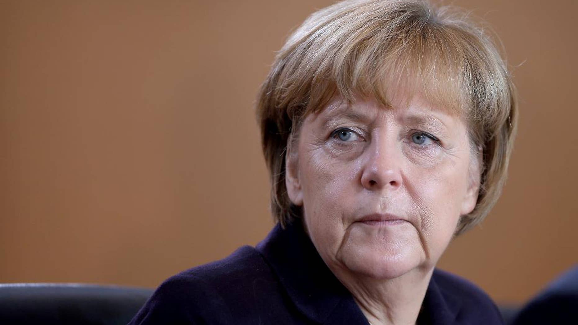 German Chancellor Angela Merkel attends the beginning of the weekly cabinet meeting at the chancellery in Berlin, Germany, Wednesday, Nov. 5, 2014. (AP Photo/Michael Sohn)