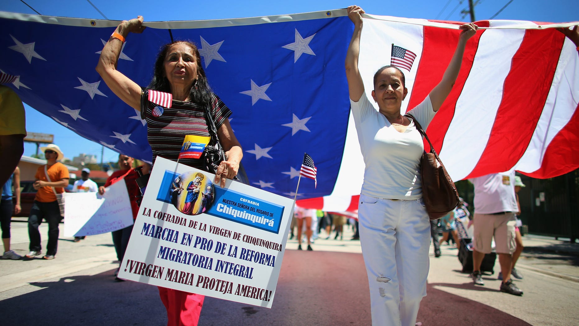 MIAMI, FL - APRIL 06: People participate in a protest march that organizers said was an attempt to get the U.S. Congress to say yes to immigration reform on April 6, 2013 in Miami, Florida. The marchers were calling for a new immigration system with a real and inclusive path to citizenship for 11 million aspiring Americans, and to keep families together. (Photo by Joe Raedle/Getty Images)