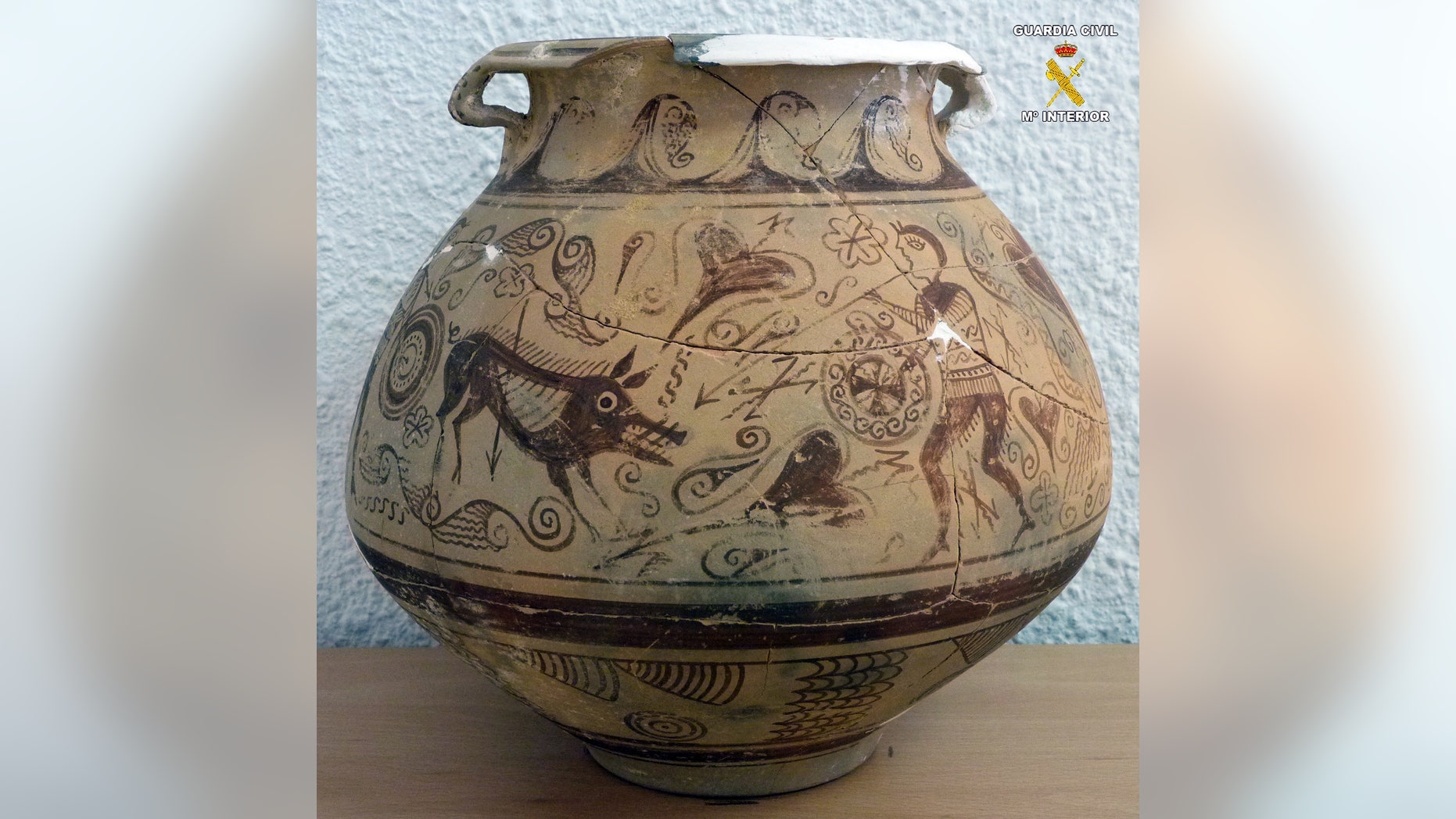 In this picture released by the Spanish Interior Ministry on Saturday, Jan. 5, 2013, a very rare vase from late second century BC that was seized by police after it was found in an antique shop in the town of El Campello, eastern Spain. Officers seized the object during a routine inspection and arrested the shop owner for allegedly receiving and handling the plundered antiquity of almost incalculable historical importance. The vase is nearly 22-centuries old and was allegedly taken from an Iberian era archeological site in the Spanish province of Alicante. (AP Photo/Interior Ministry) Eds note: Logo at top right put on by source.