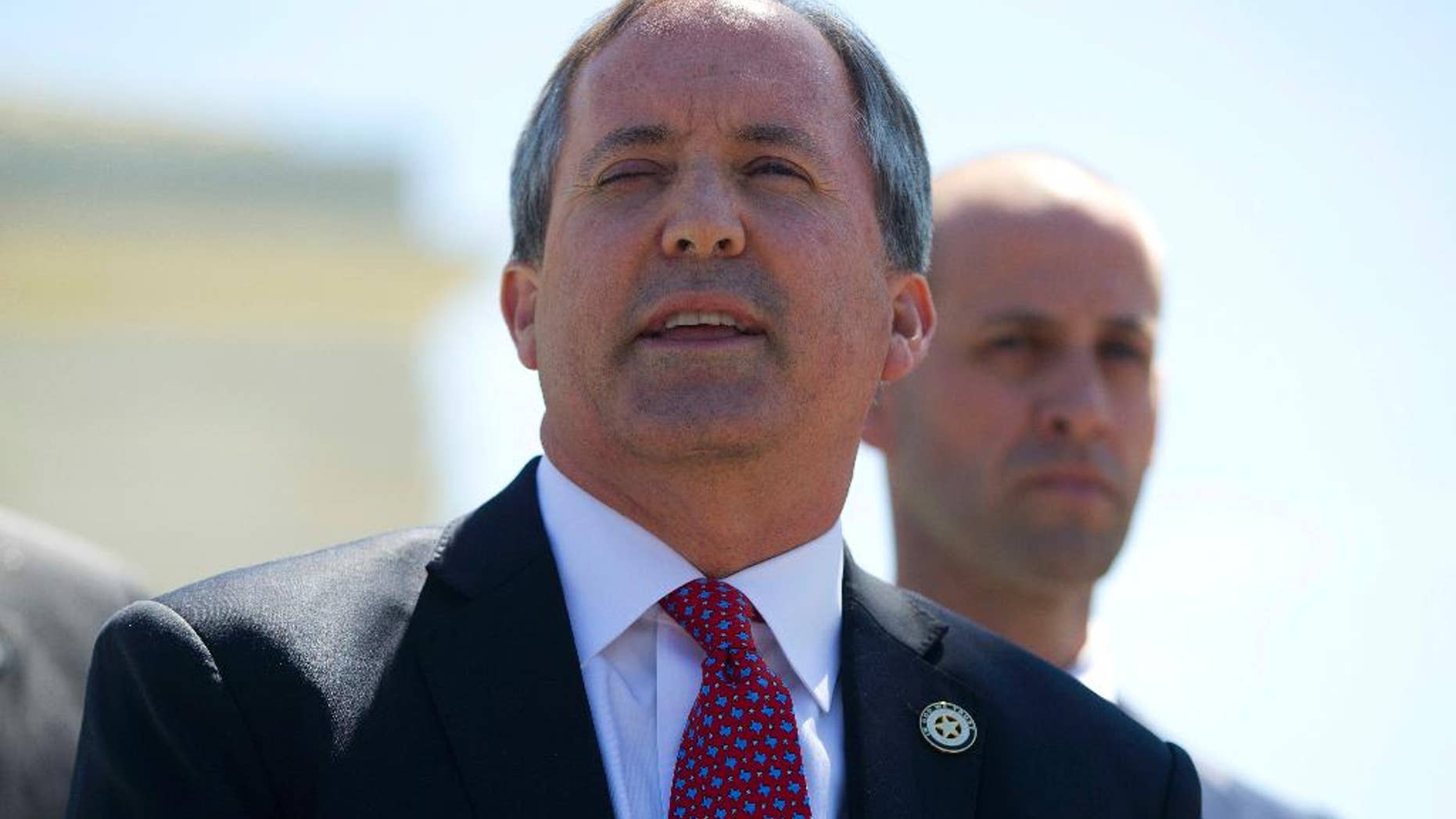 File - In this April 18, 2016, file photo, Texas Attorney General Ken Paxton meet with members of the media at the Supreme Court in Washington. A federal judge has dismissed a lawsuit that Texas brought against the federal government in hopes of halting the arrival of Syrian refugees. (AP Photo/Pablo Martinez Monsivais, File)