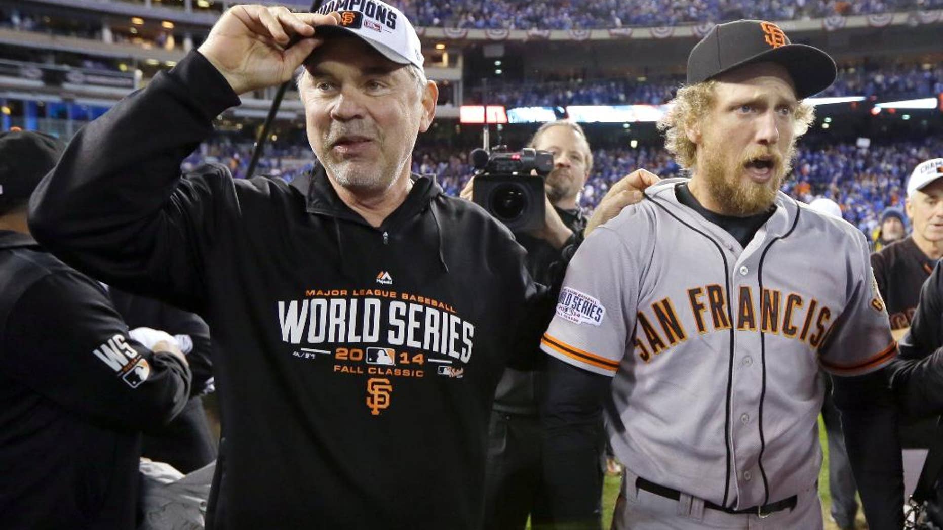 San Francisco Giants manager Bruce Bochy and Hunter Pence celebrate after Game 7 of baseball's World Series against the Kansas City Royals Wednesday, Oct. 29, 2014, in Kansas City, Mo. The Giants won 3-2 to win the series. (AP Photo/Charlie Neibergall)